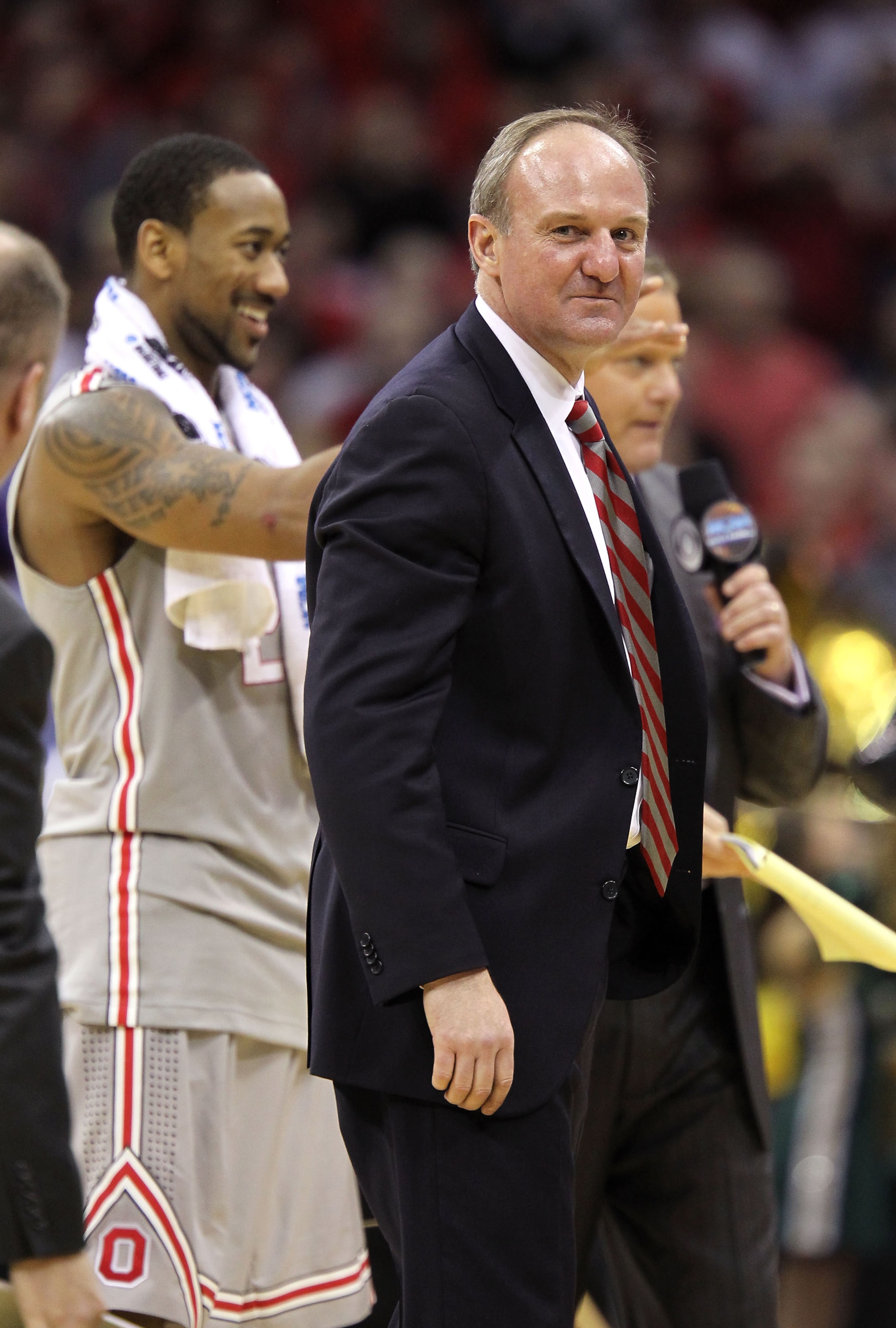 CLEVELAND, OH - MARCH 20:  Head coach Thad Matta of the Ohio State Buckeyes stands on the court with David Lighty #23 after defeating the George Mason Patriots during the third of the 2011 NCAA men's basketball tournament at Quicken Loans Arena on March 2