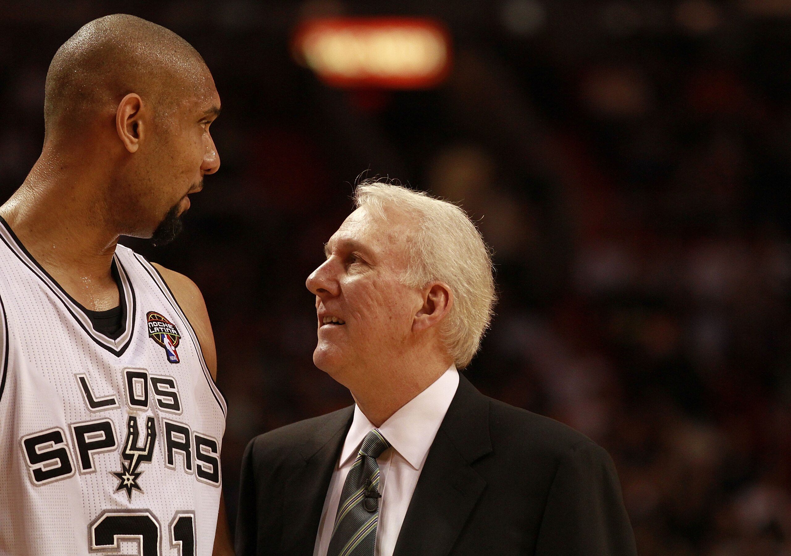 MIAMI - MARCH 14:  Center Tim Duncan #21 of the San Antonio Spurs chats with his Coach Greg Popovich against the Miami Heat at American Airlines Arena on March 14, 2011 in Miami, Florida. NOTE TO USER: User expressly acknowledges and agrees that, by downl