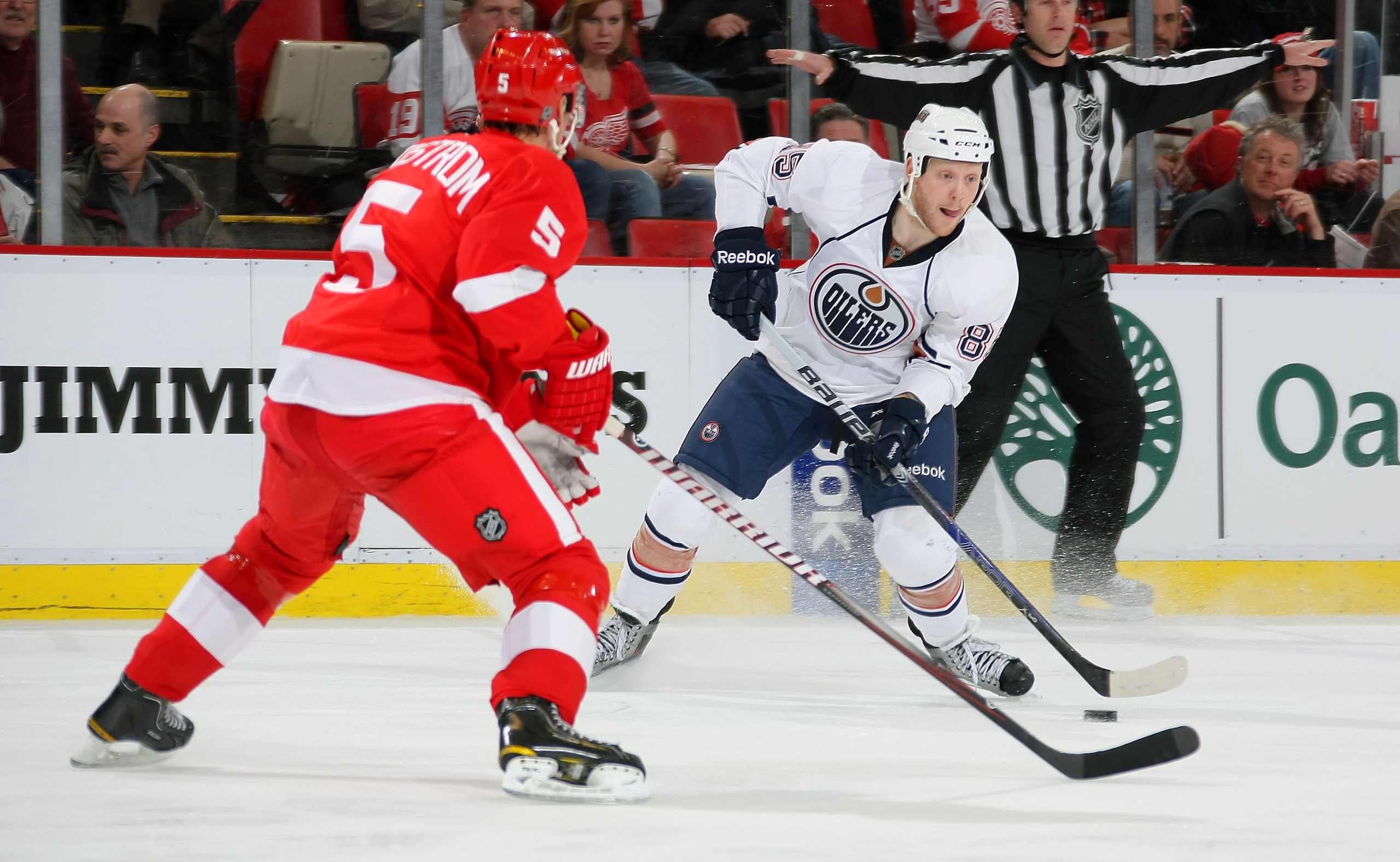 DETROIT, MI - MARCH 11:  Liam Reddox #85 of the Edmonton Oilers carries the puck as Nicklas Lidstrom #5 of the Detroit Red Wings defends during their NHL game at Joe Louis Arena on March 11, 2011 in Detroit, Michigan.  (Photo by Dave Sandford/Getty Images