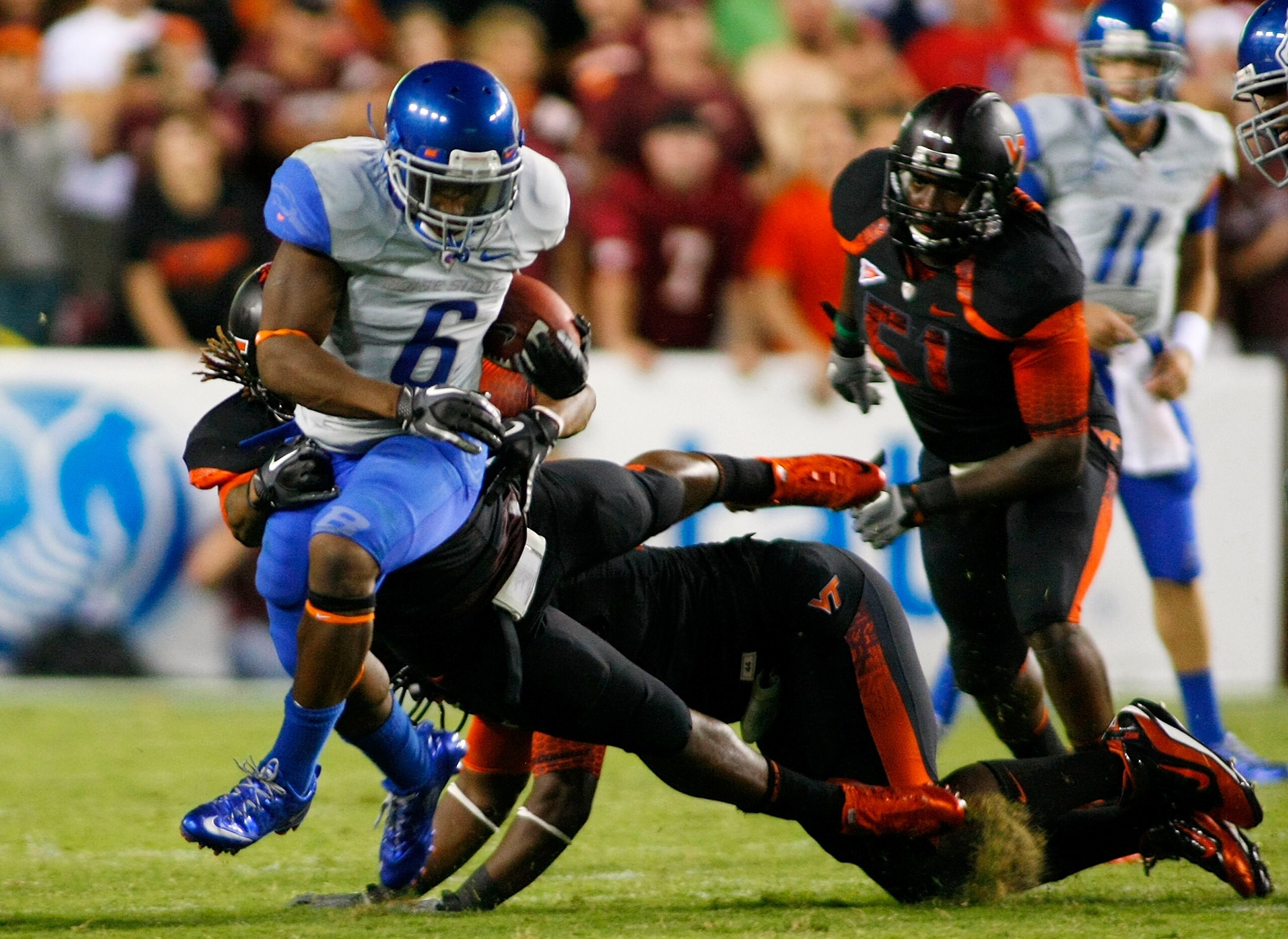 LANDOVER, MD - SEPTEMBER 06:  Running back D.J. Harper #6 of the Boise State Broncos runs with the ball past linebacker Lyndell Gibson #44 of the Virginia Tech Hokies at FedExField on September 6, 2010 in Landover, Maryland.  (Photo by Geoff Burke/Getty I