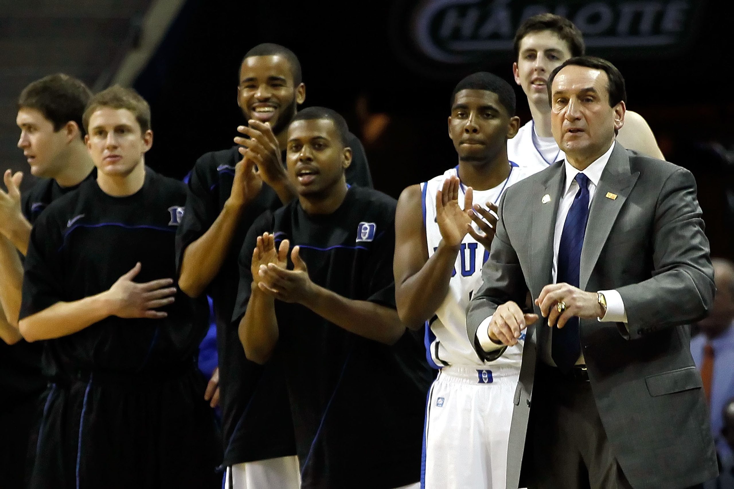 CHARLOTTE, NC - MARCH 18:  (R) Head coach Mike Krzyzewski of the Duke Blue Devils and the rest of the Blue Devils bench cheer after a basket by Andre Dawkins #20 while taking on the Hampton Pirates during the second round of the 2011 NCAA men's basketball