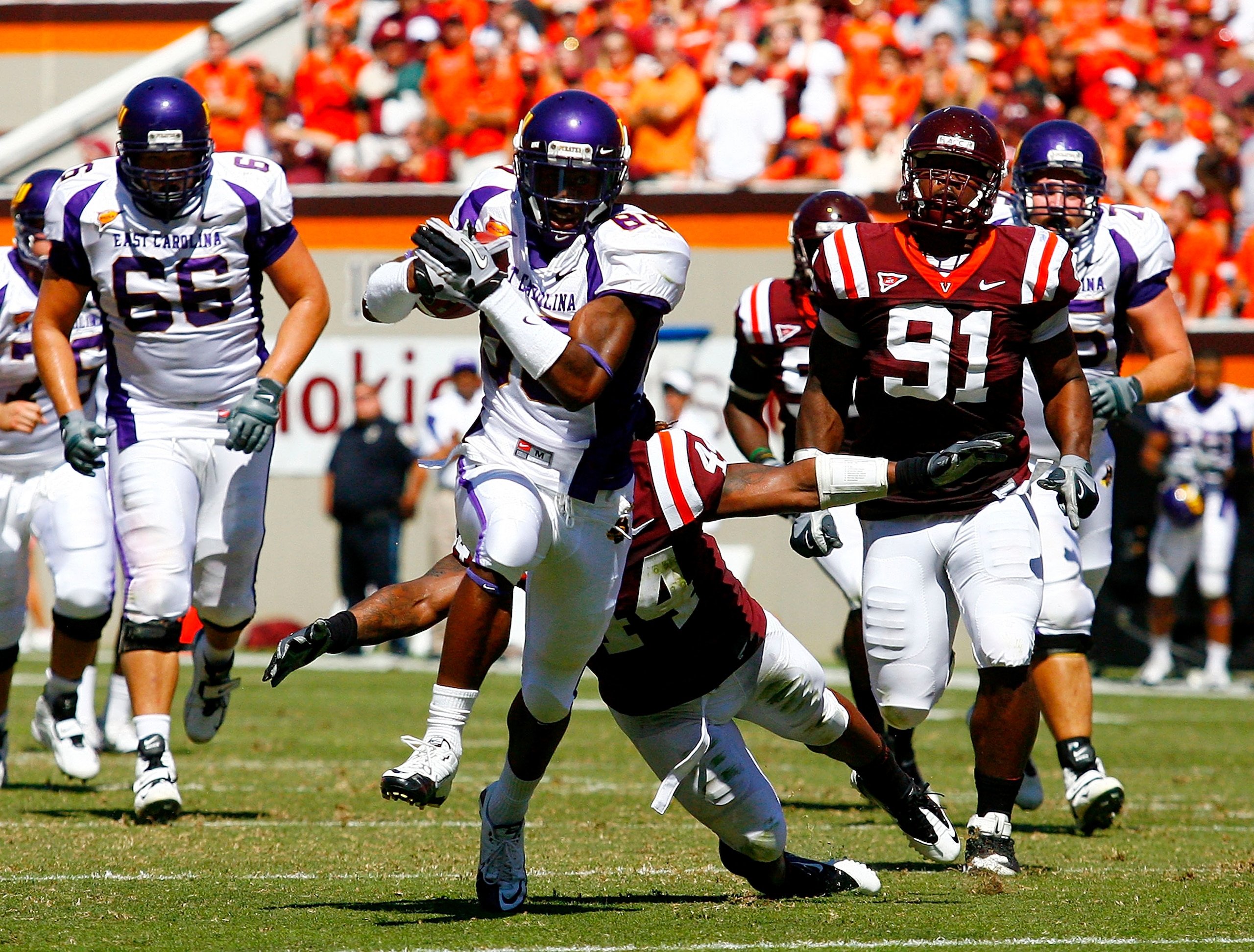BLACKSBURG, VA - SEPTEMBER 18: Wide receiver Lance Lewis #88 of the East Carolina Pirates runs with the ball as linebacker Lyndell Gibson #44 and defensive tackle John Graves #91 of the Virginia Tech Hokies chase at Lane Stadium on September 18, 2010 in B
