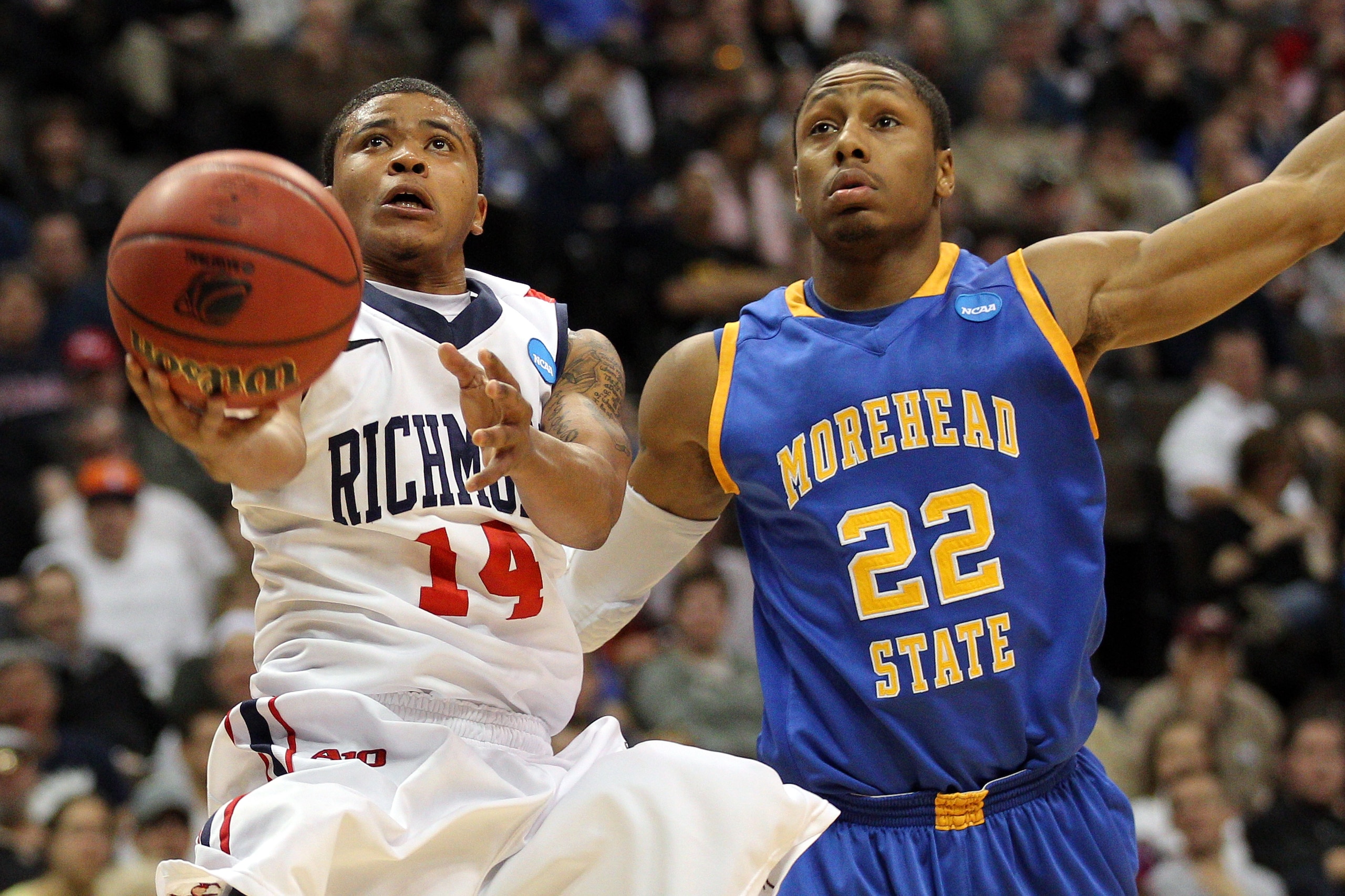 DENVER, CO - MARCH 19:  Kevin Anderson #14 of the Richmond Spiders goes to the hoop against Demonte Harper #22 of the Morehead State Eagles during the third round of the 2011 NCAA men's basketball tournament at Pepsi Center on March 19, 2011 in Denver, Co
