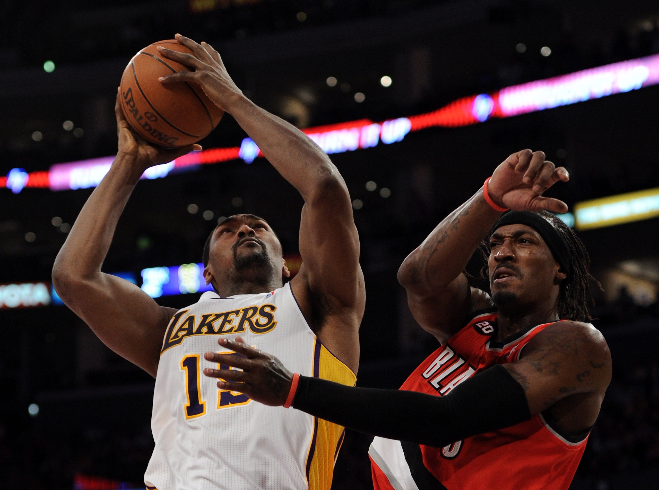 LOS ANGELES, CA - MARCH 20:  Ron Artest #15 of the Los Angeles Lakers grabs a rebound away from Gerald Wallace #3 at the Staples Center on March 20, 2011 in Los Angeles, California.  NOTE TO USER: User expressly acknowledges and agrees that, by downloadin