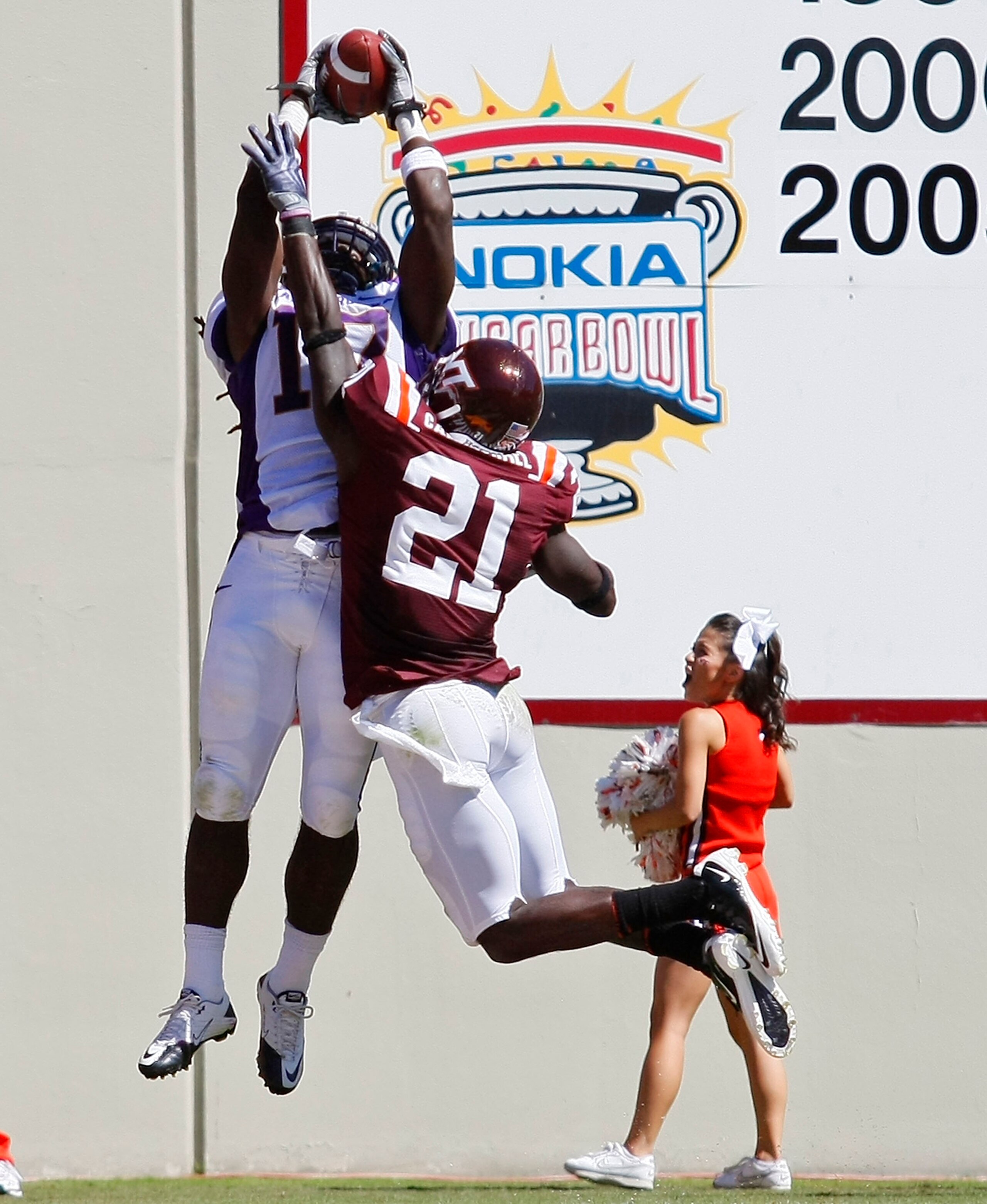 BLACKSBURG, VA - SEPTEMBER 18: Wide receiver Dwayne Harris #17 of the East Carolina Pirates leaps to catch a pass for a touchdown over cornerback Rashad Carmichael #21 of the Virginia Tech Hokies at Lane Stadium on September 18, 2010 in Blacksburg, Virgi BLACKSBURG, VA - SEPTEMBER 18: Wide receiver Dwayne Harris #17 of the East Carolina Pirates leaps to catch a pass for a touchdown over cornerback Rashad Carmichael #21 of the Virginia Tech Hokies at Lane Stadium on September 18, 2010 in Blacksburg, Virgi