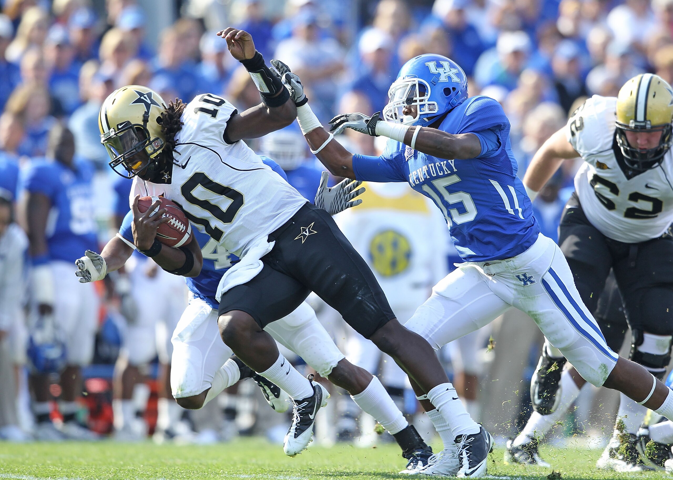 LEXINGTON, KY - NOVEMBER 13:  Larry Smith #10 of the Vanderbilt Commodores is pushed down by Martavius Neloms #15 of the Kentucky Wildcats during the game against  at Commonwealth Stadium on November 13, 2010 in Lexington, Kentucky.  (Photo by Andy Lyons/