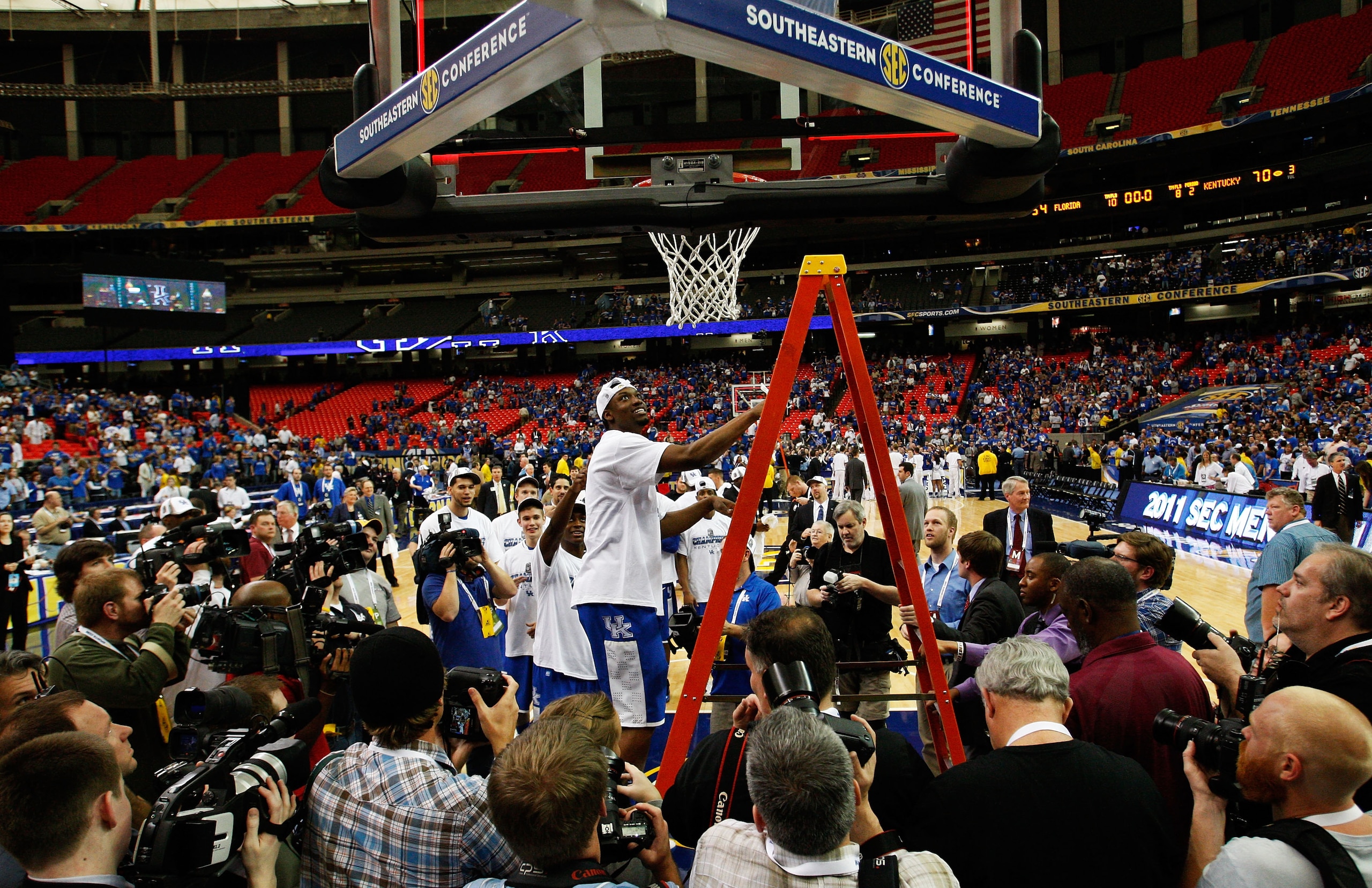 ATLANTA - MARCH 13:  Deandre Liggins #34 of the Kentucky Wildcats cuts down the net after their 70 to 54 win over the Florida Gators in the championship game of the SEC Men's Basketball Tournament at Georgia Dome on March 13, 2011 in Atlanta, Georgia.  (P