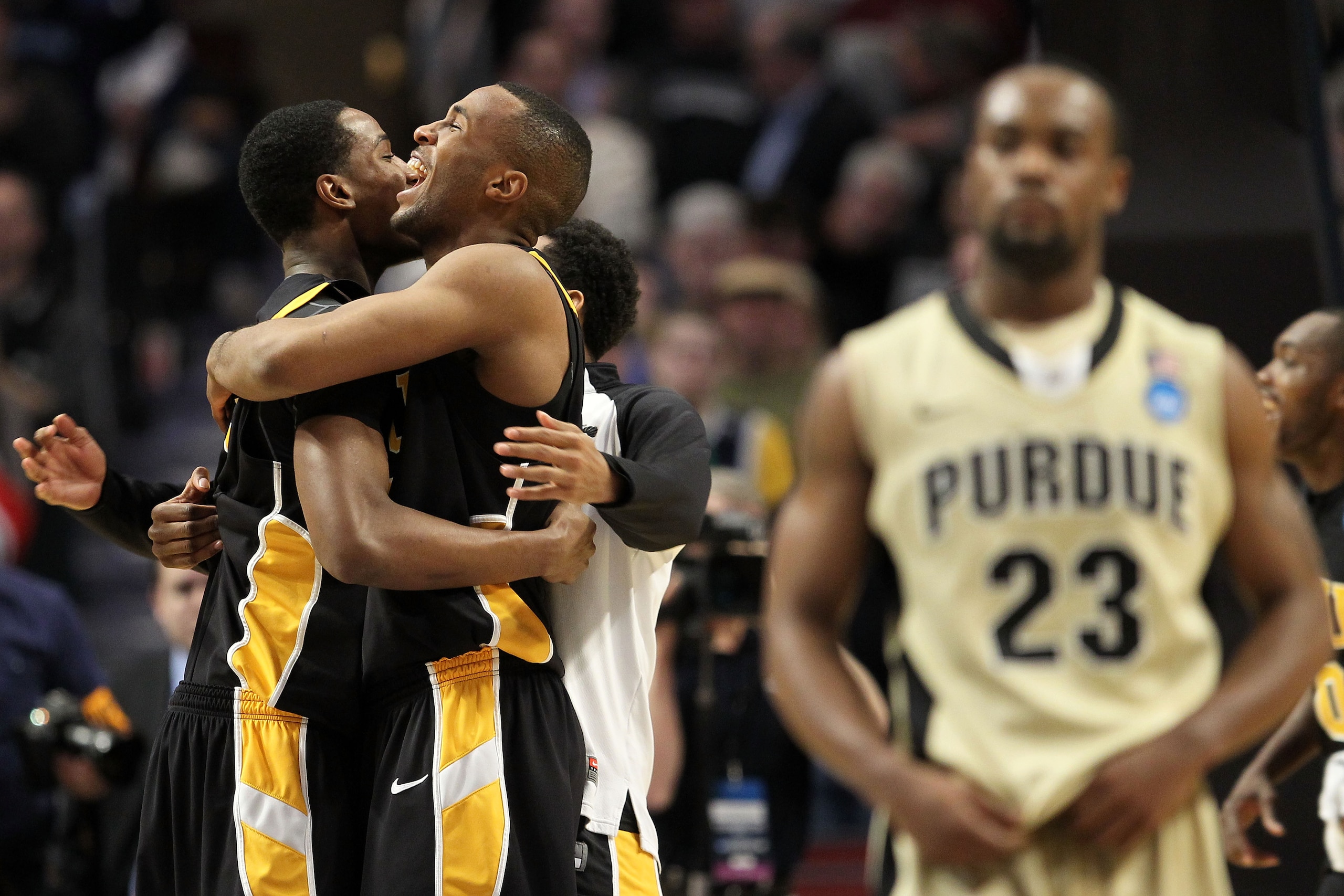 CHICAGO, IL - MARCH 20:  Rob Brandenberg #23 and D.J. Haley #33 of the Virginia Commonwealth Rams celebrate their win as Lewis Jackson #23 of the Purdue Boilermakers walks off the court in the second half during the third round of the 2011 NCAA men's bask