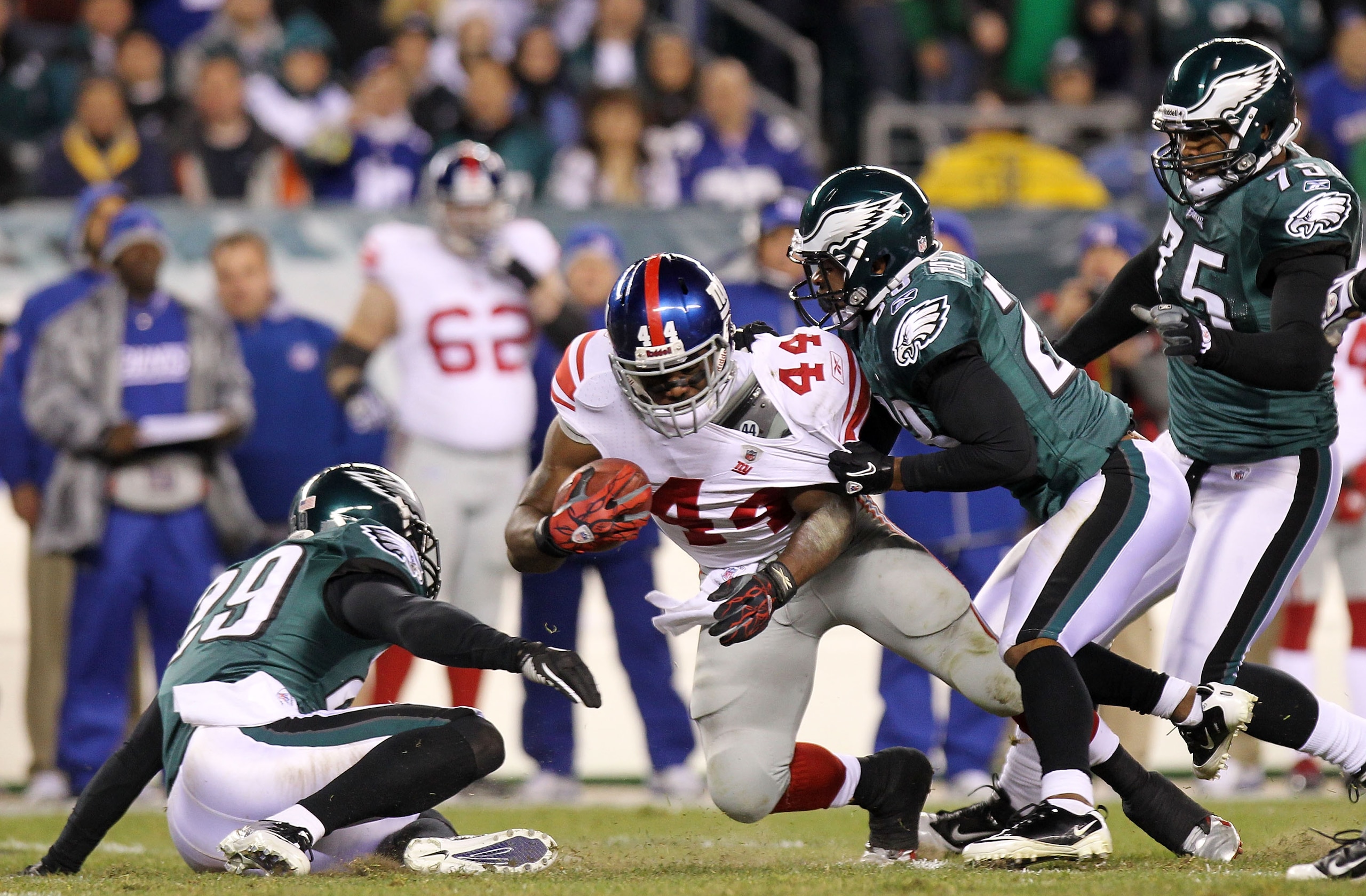 PHILADELPHIA, PA - NOVEMBER 21:  Ahmad Bradshaw #44 of the New York Giants is tackled by Dimitri Patterson #23 and Marlin Jackson #28 of the Philadelphia Eagles at Lincoln Financial Field on November 21, 2010 in Philadelphia, Pennsylvania.  (Photo by Nick
