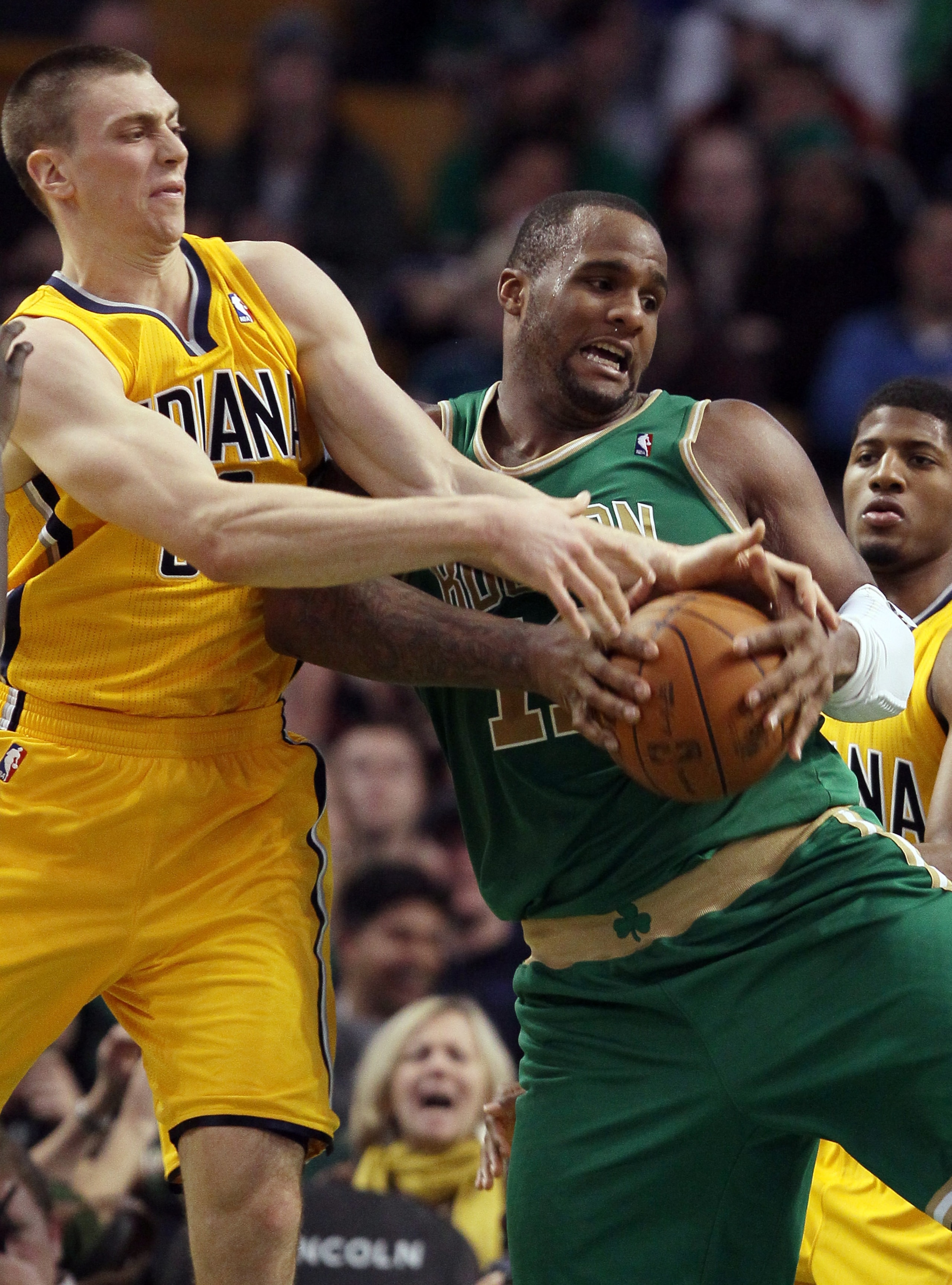 BOSTON, MA - MARCH 16:  Glen Davis #11 of the Boston Celtics fights to keep the ball as Tyler Hansbrough #50 of the Indiana Pacers defends on March 16, 2011 at the TD Garden in Boston, Massachusetts. The Celtics defeated the Indiana Pacers 92-80. NOTE TO