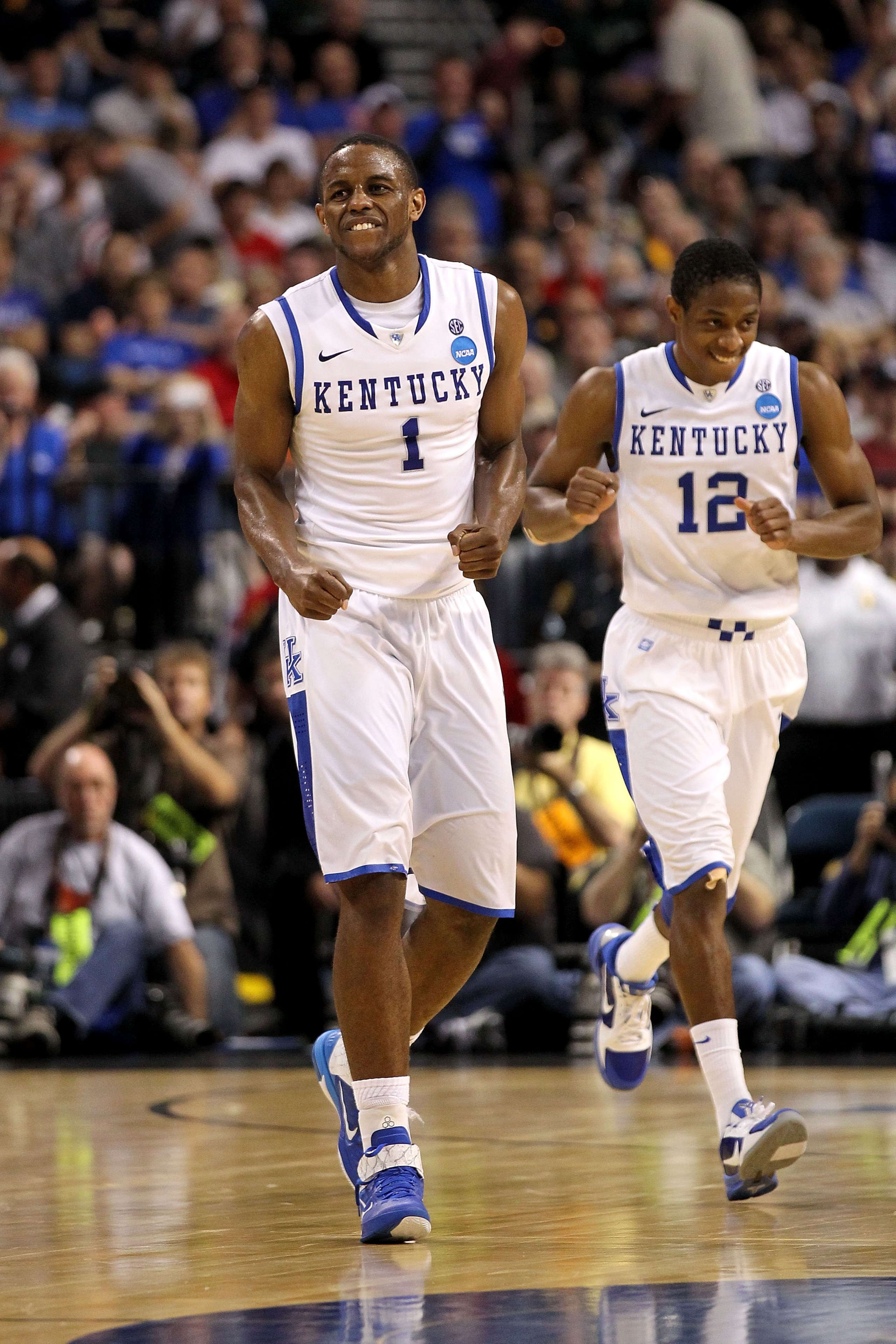 TAMPA, FL - MARCH 19:  Darius Miller #1 and Brandon Knight #12 of the Kentucky Wildcats celebrate a play against the West Virginia Mountaineers during the third round of the 2011 NCAA men's basketball tournament at St. Pete Times Forum on March 19, 2011 i