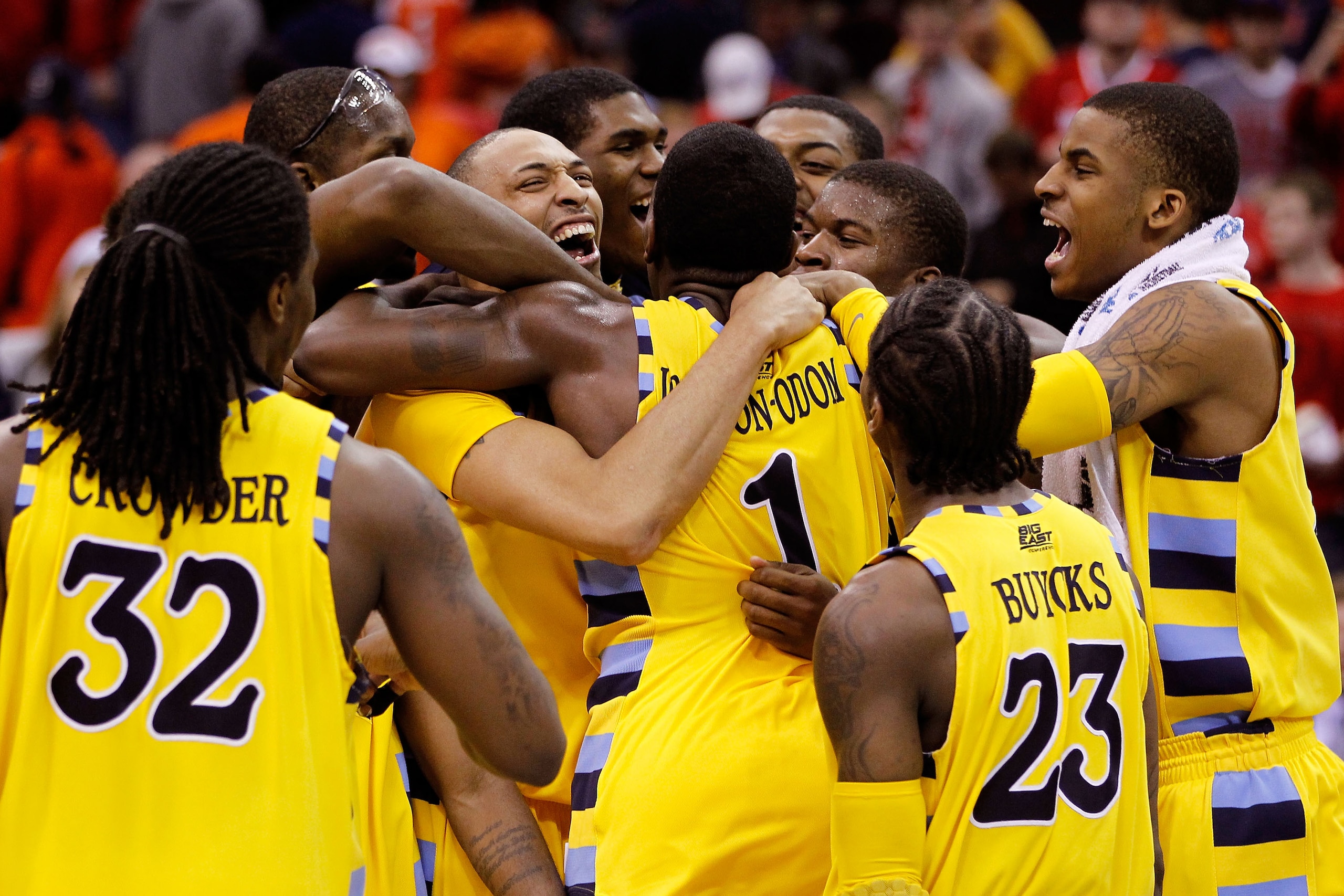 CLEVELAND, OH - MARCH 20:  Jae Crowder #32, Joseph Fulce #21, Darius Johnson-Odom #1 and Dwight Buycks #23 of the Marquette Golden Eagles celebrate with teammates after defeating the Syracuse Orange during the third of the 2011 NCAA men's basketball tourn