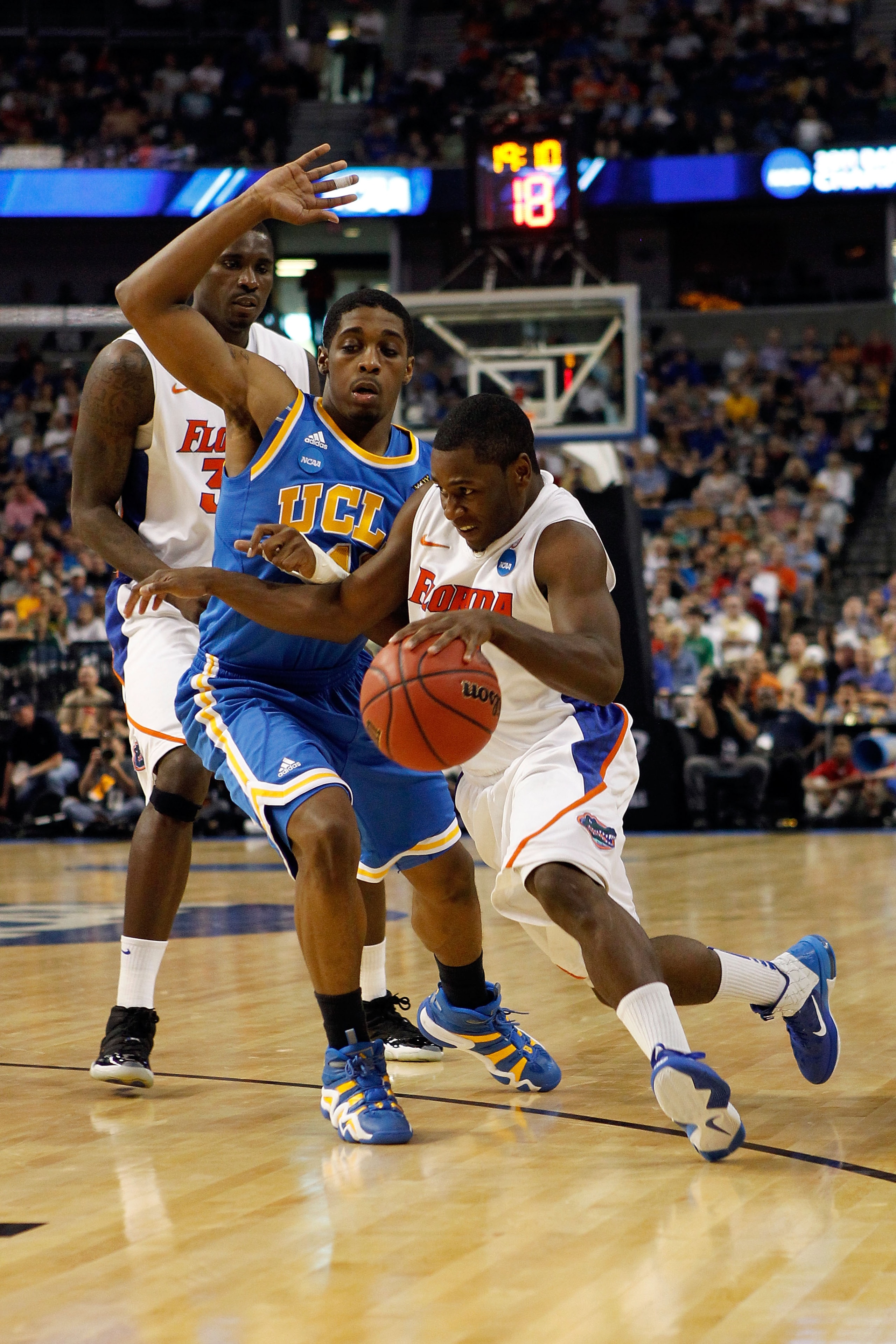 TAMPA, FL - MARCH 19:  Erving Walker #11 of the Florida Gators drives against Lazeric Jones #11 of the UCLA Bruins during the third round of the 2011 NCAA men's basketball tournament at St. Pete Times Forum on March 19, 2011 in Tampa, Florida.  (Photo by