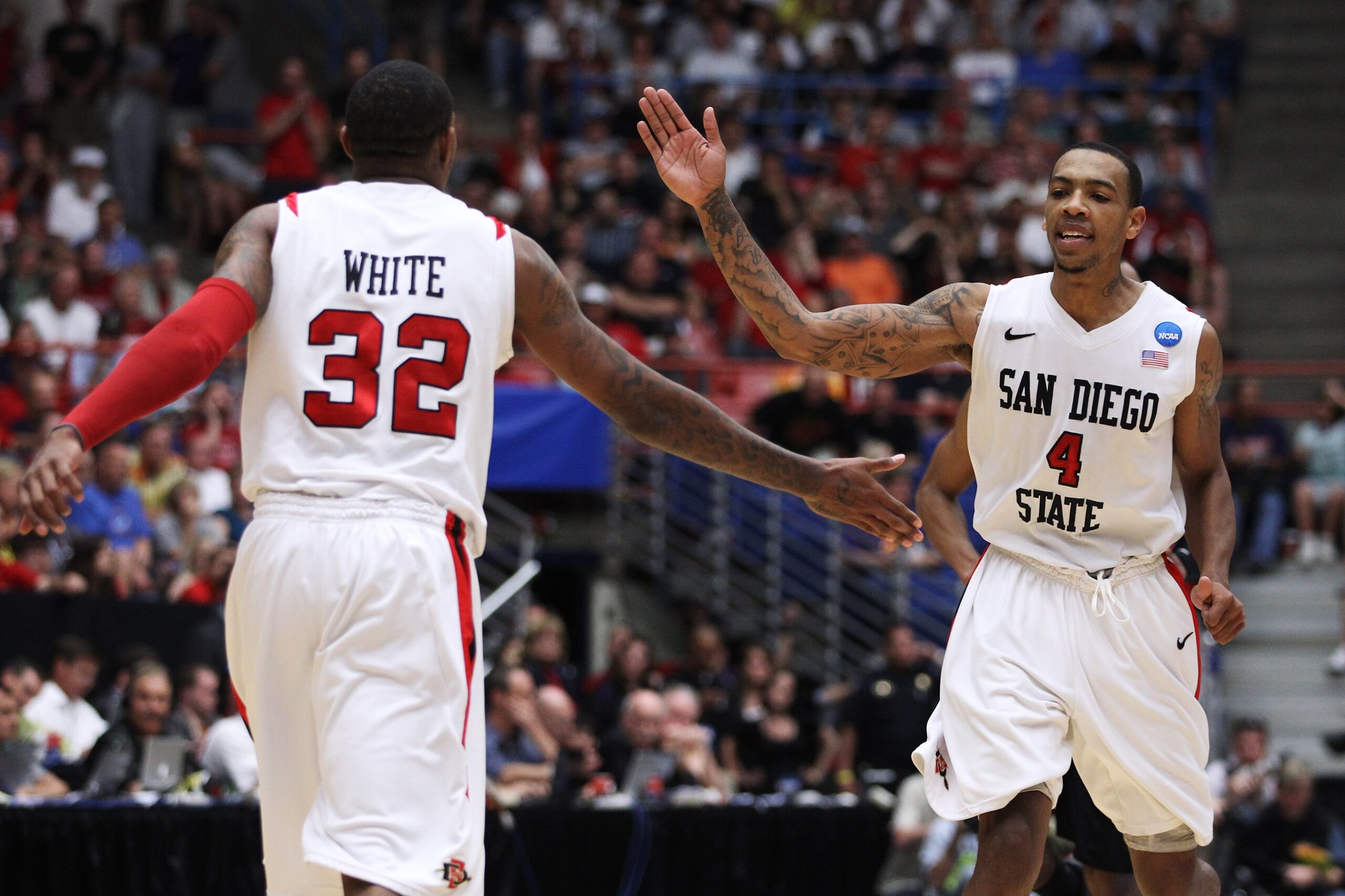 TUCSON, AZ - MARCH 19:  Malcolm Thomas #4 and Billy White #32 of the San Diego State Aztecs celebrate after defeating the Temple Owls 71 to 64 in double overtime during the third round of the 2011 NCAA men's basketball tournament at McKale Center on March