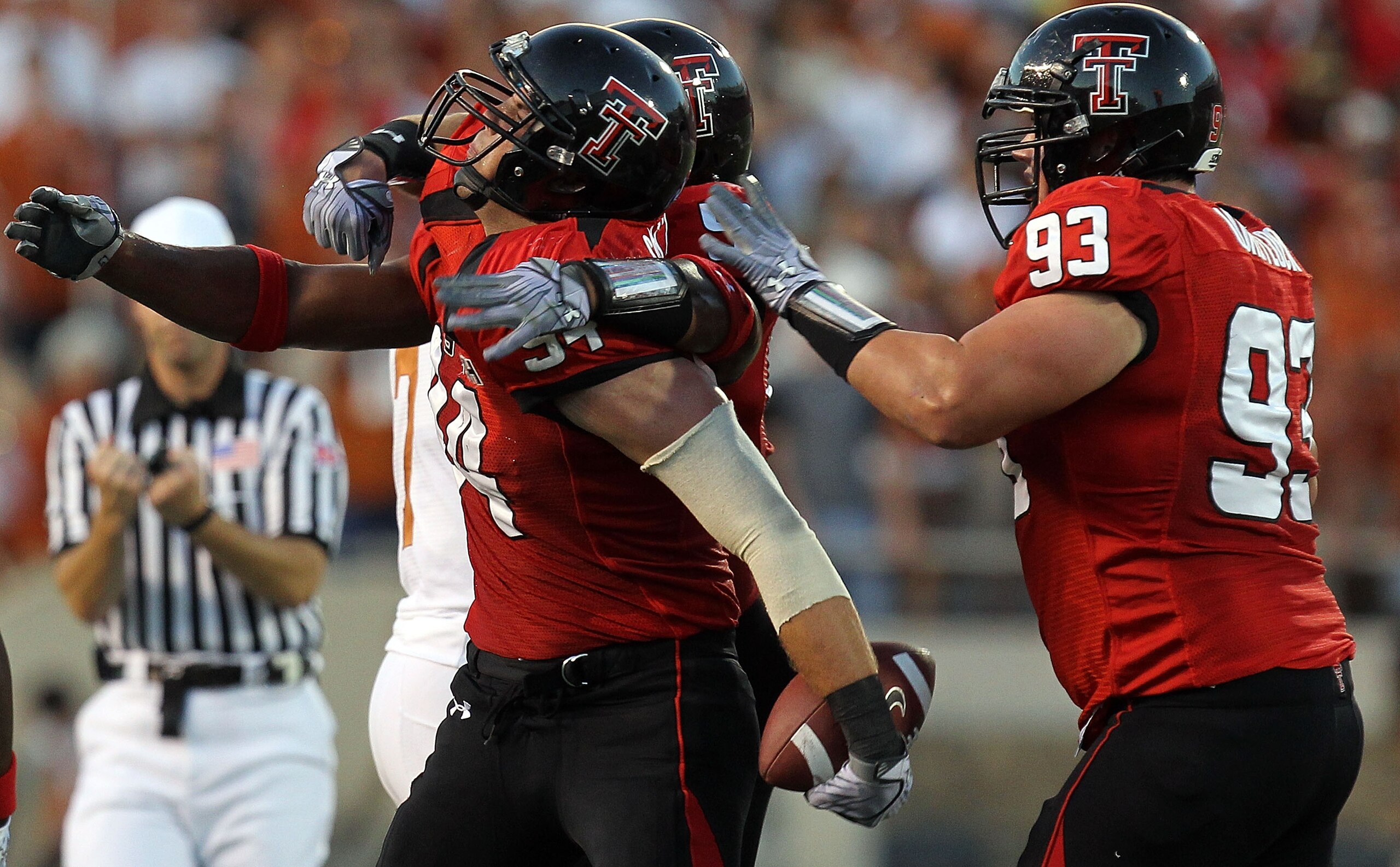LUBBOCK, TX - SEPTEMBER 18:  Defensive end Scott Smith #94 of the Texas Tech Red Raiders celebrates a pass interception against the Texas Longhorns at Jones AT&T Stadium on September 18, 2010 in Lubbock, Texas.  (Photo by Ronald Martinez/Getty Images)