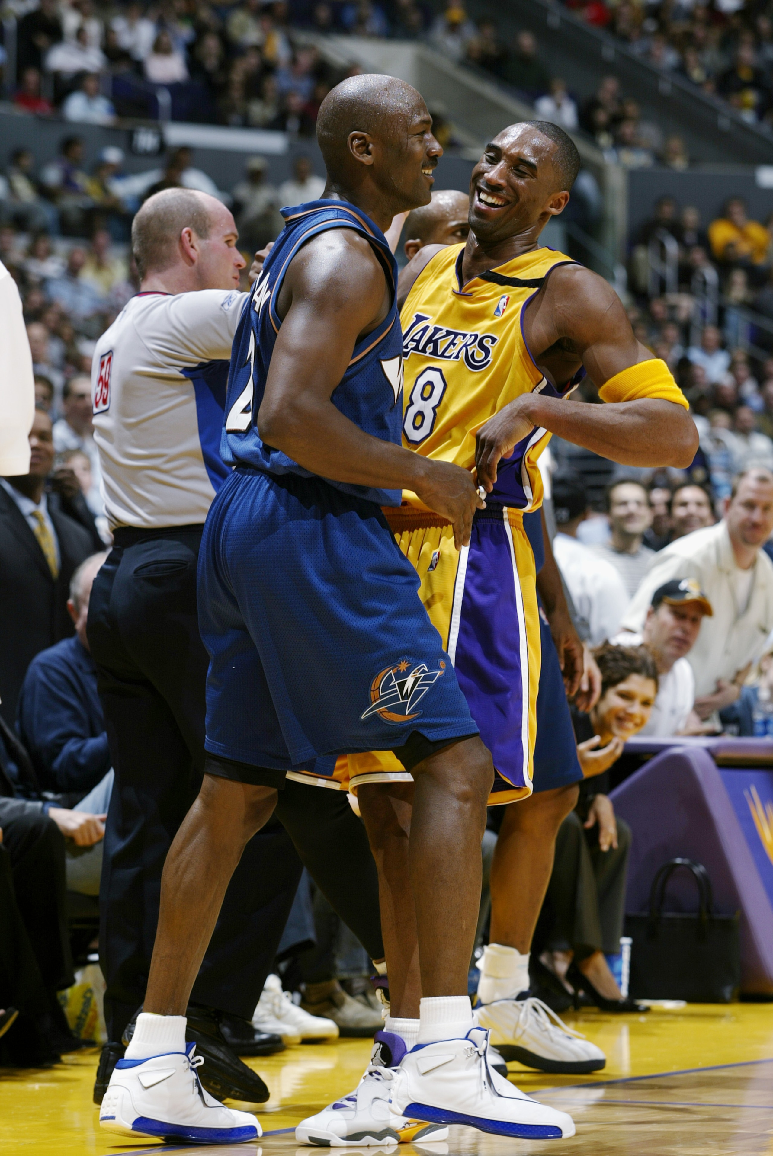 LOS ANGELES - MARCH 28:  Kobe Bryant #8 of the Los Angeles Lakers shares a laugh with Michael Jordan #23 of the Washington Wizards during the game at Staples Center on March 28, 2003 in Los Angeles, California.  The Lakers won 108-94.  NOTE TO USER: User