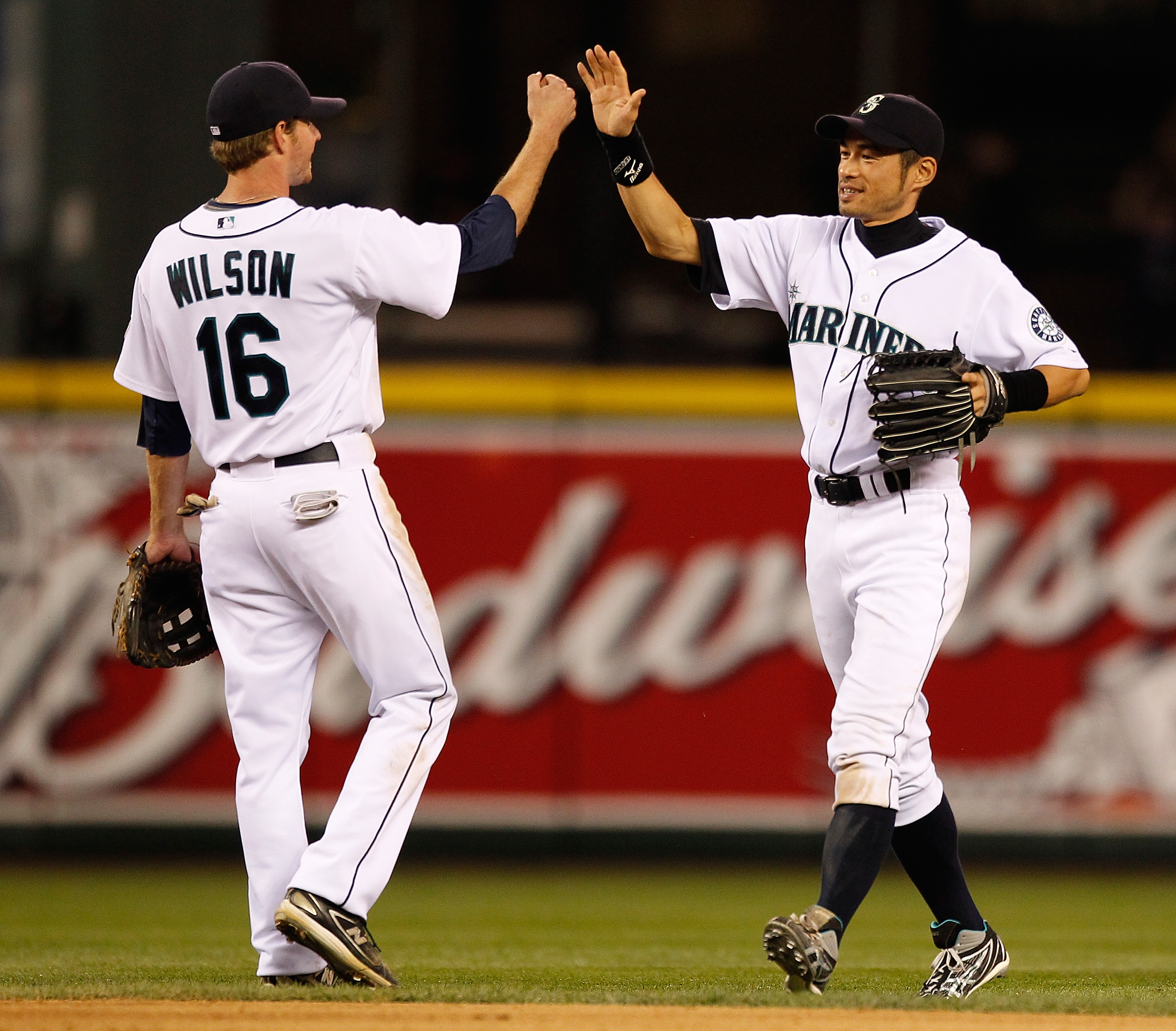 SEATTLE - JUNE 22:  Ichiro Suzuki #51 of the Seattle Mariners celebrates with Josh Wilson #16 after defeating the Chicago Cubs 2-0 on June 22, 2010 at Safeco Field in Seattle, Washington. (Photo by Otto Greule Jr/Getty Images)
