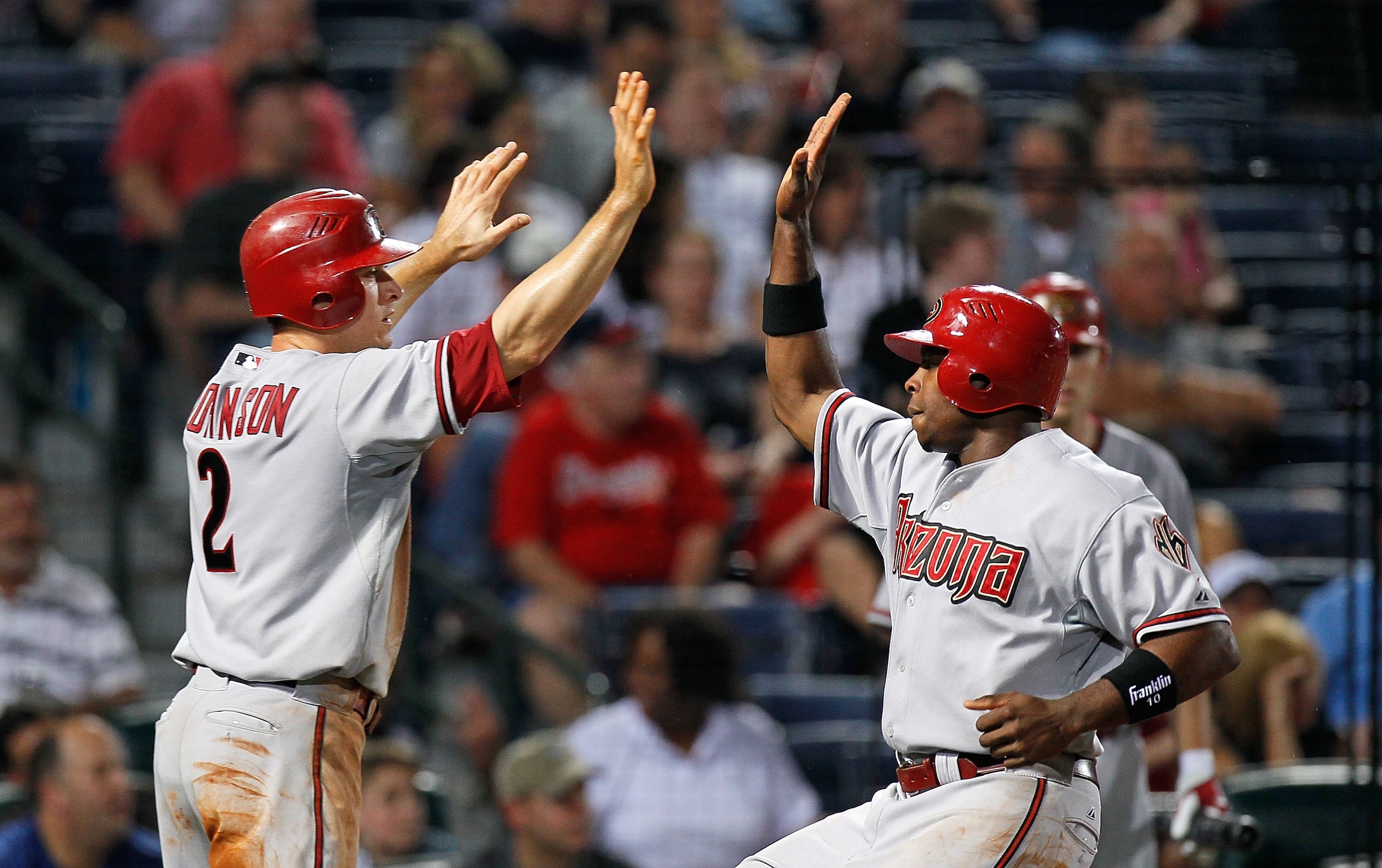 ATLANTA - MAY 14:  Kelly Johnson #2 and Justin Upton #10 of the Arizona Diamondbacks celebrate after scoring against the Atlanta Braves at Turner Field on May 14, 2010 in Atlanta, Georgia.  (Photo by Kevin C. Cox/Getty Images)