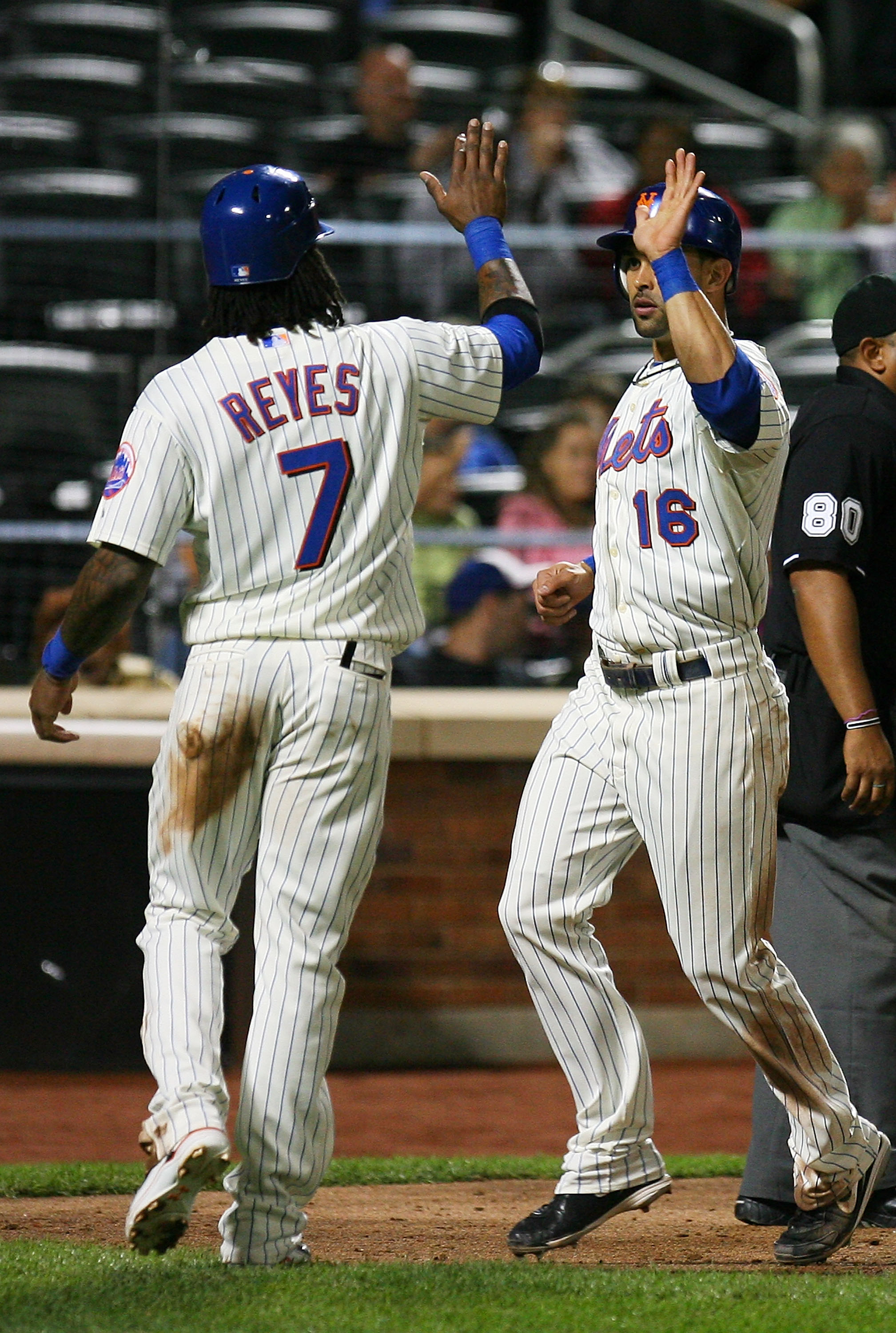 NEW YORK - SEPTEMBER 14: Jose Reyes #7 of the of the New York Mets celebrates with temmate Angel Pagan #16 after running in a two-run double from Carlos Beltran #15 (not seen) of the Mets during the fourth inning against Pittsburgh Pirates on September 14