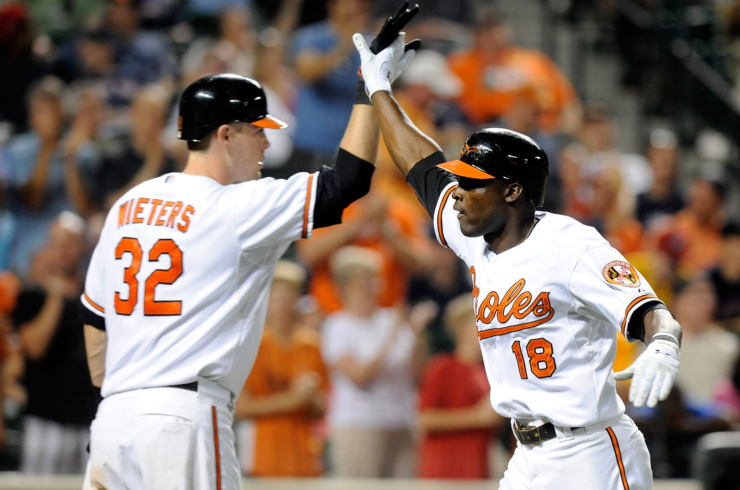 BALTIMORE - AUGUST 31:  Felix Pie #18 of the Baltimore Orioles celebrates with Matt Wieters #32 after hitting a home run in the eighth inning against the Boston Red Sox at Camden Yards on August 31, 2010 in Baltimore, Maryland.  (Photo by Greg Fiume/Getty