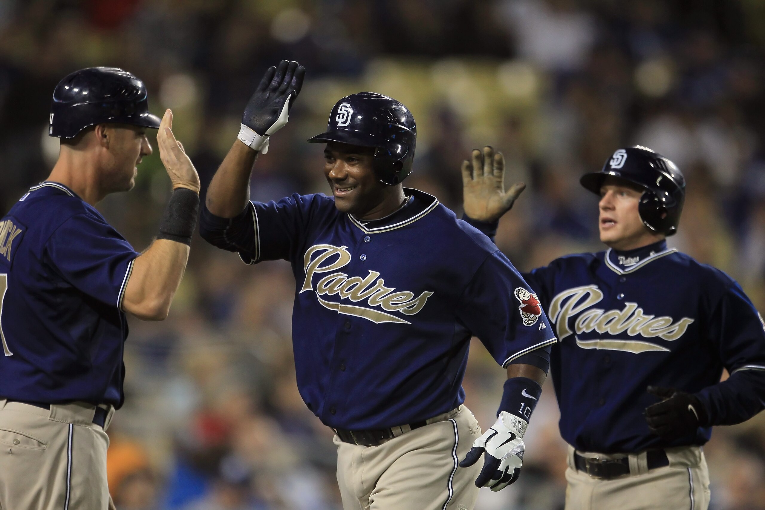 LOS ANGELES, CA - SEPTEMBER 22:  (L-R) Ryan Ludwick #47, Miguel Tejada #10 and David Eckstein #22 of the San Diego Padres celebrate Tejada's two-run home run in the third inning against the Los Angeles Dodgers at Dodger Stadium on September 22, 2010 in Lo