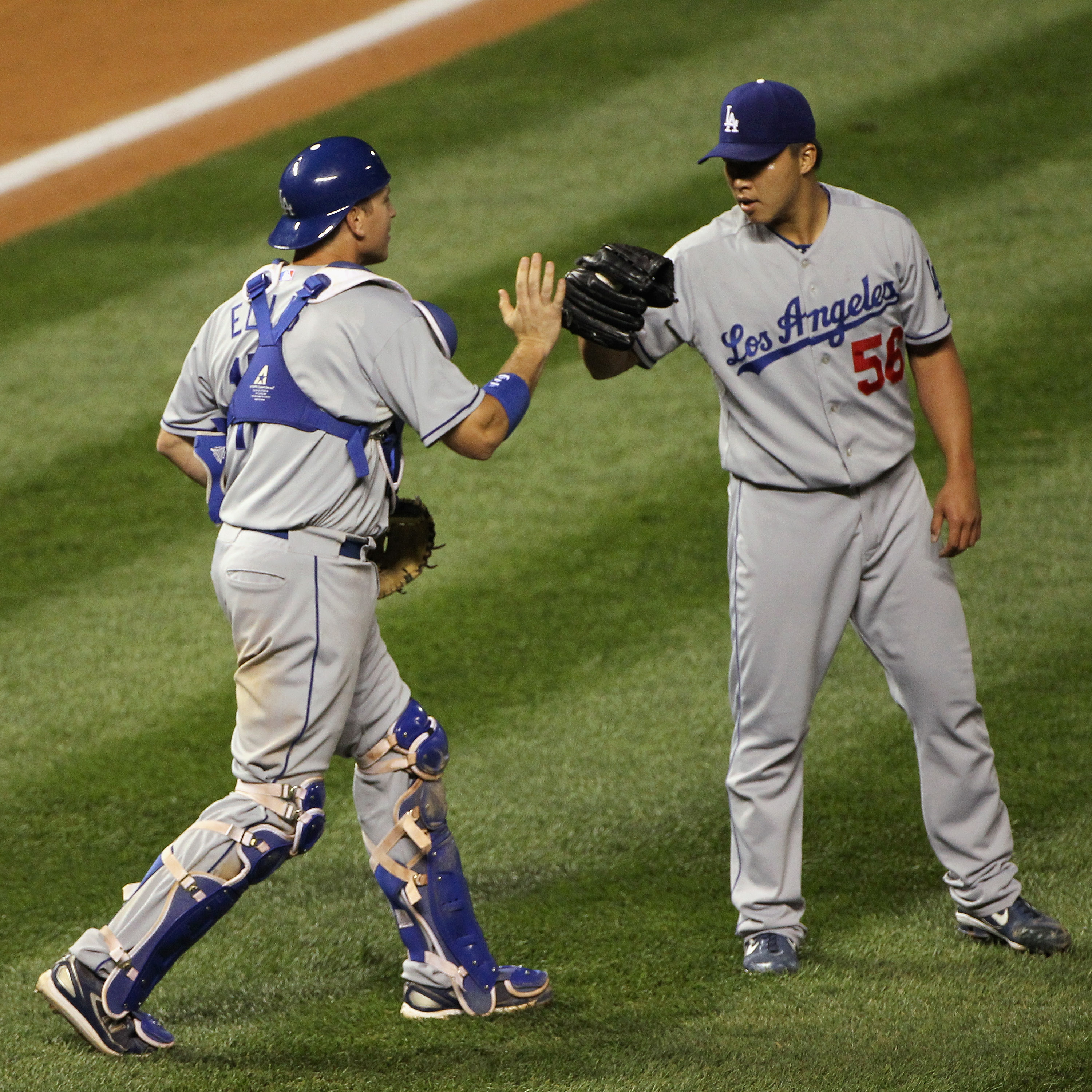 DENVER - SEPTEMBER 27:  Catcher A.J. Ellis #17 and relief pitcher Hong-Chih Kuo #56 of the Los Angeles Dodgers celebrate after the final out against the Colorado Rockies at Coors Field on September 25, 2010 in Denver, Colorado. Kuo earned the save as the