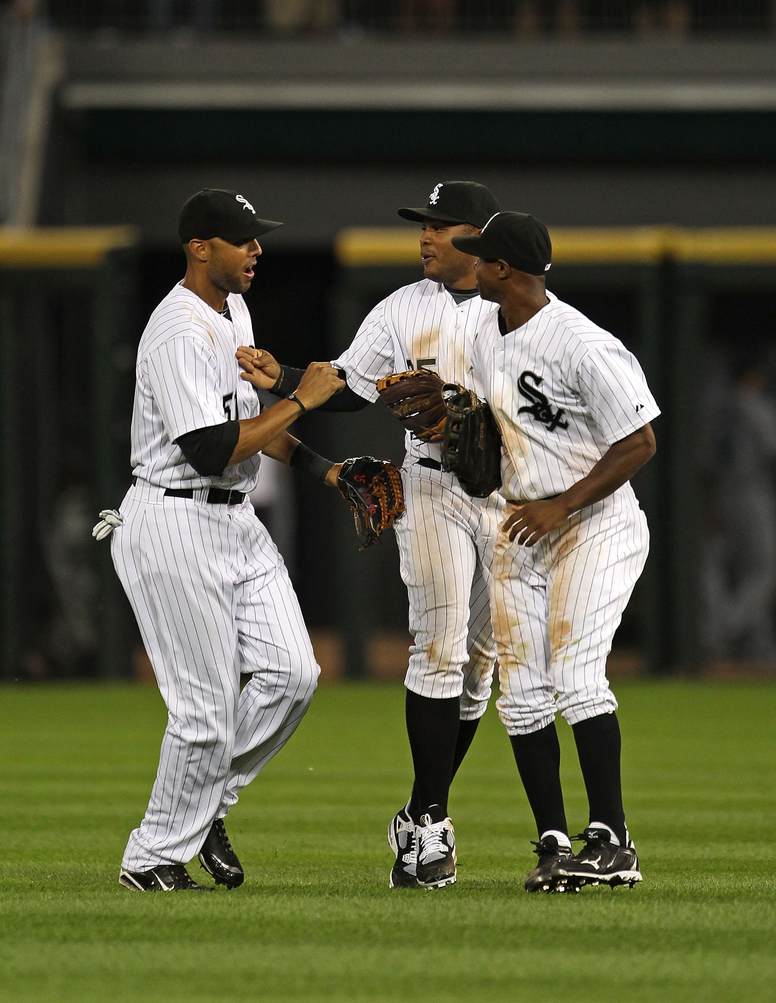 CHICAGO - JULY 26: (L-R) Alex Rios #51, Andruw Jones #25 and Juan Pierre #1 of the Chicago White Sox celebrate a win over the Seattle Mariners at U.S. Cellular Field on July 26, 2010 in Chicago, Illinois. The White Sox defeated the Mariners 6-1. (Photo by