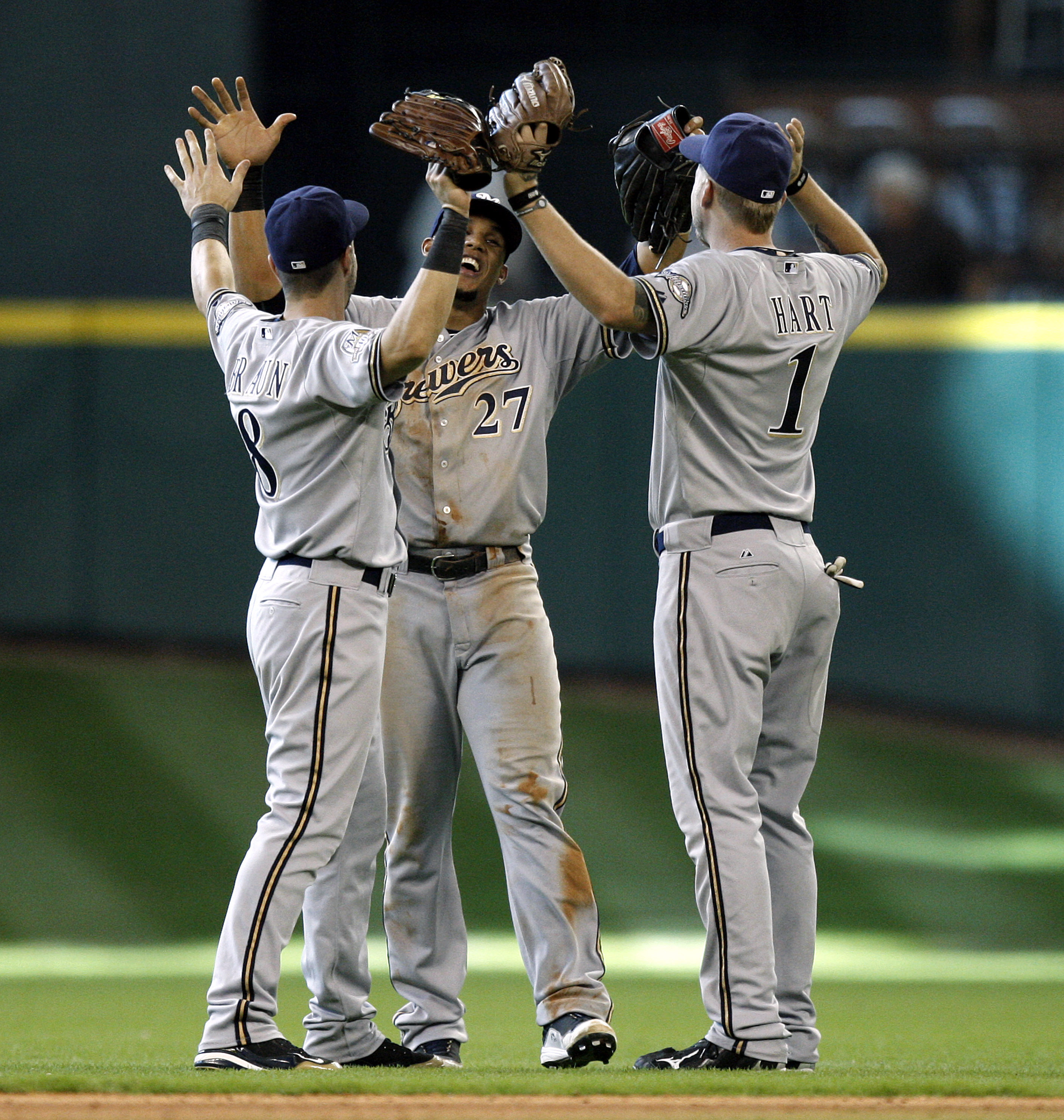 HOUSTON - SEPTEMBER 15:  Carlos Gomez, center, Ryan Braun, left, and Corey Hart of the Milwaukee Brewers celebrate their win over the Houston Astros 8-6 in ten innings at Minute Maid Park on September 15, 2010 in Houston, Texas.  (Photo by Bob Levey/Getty