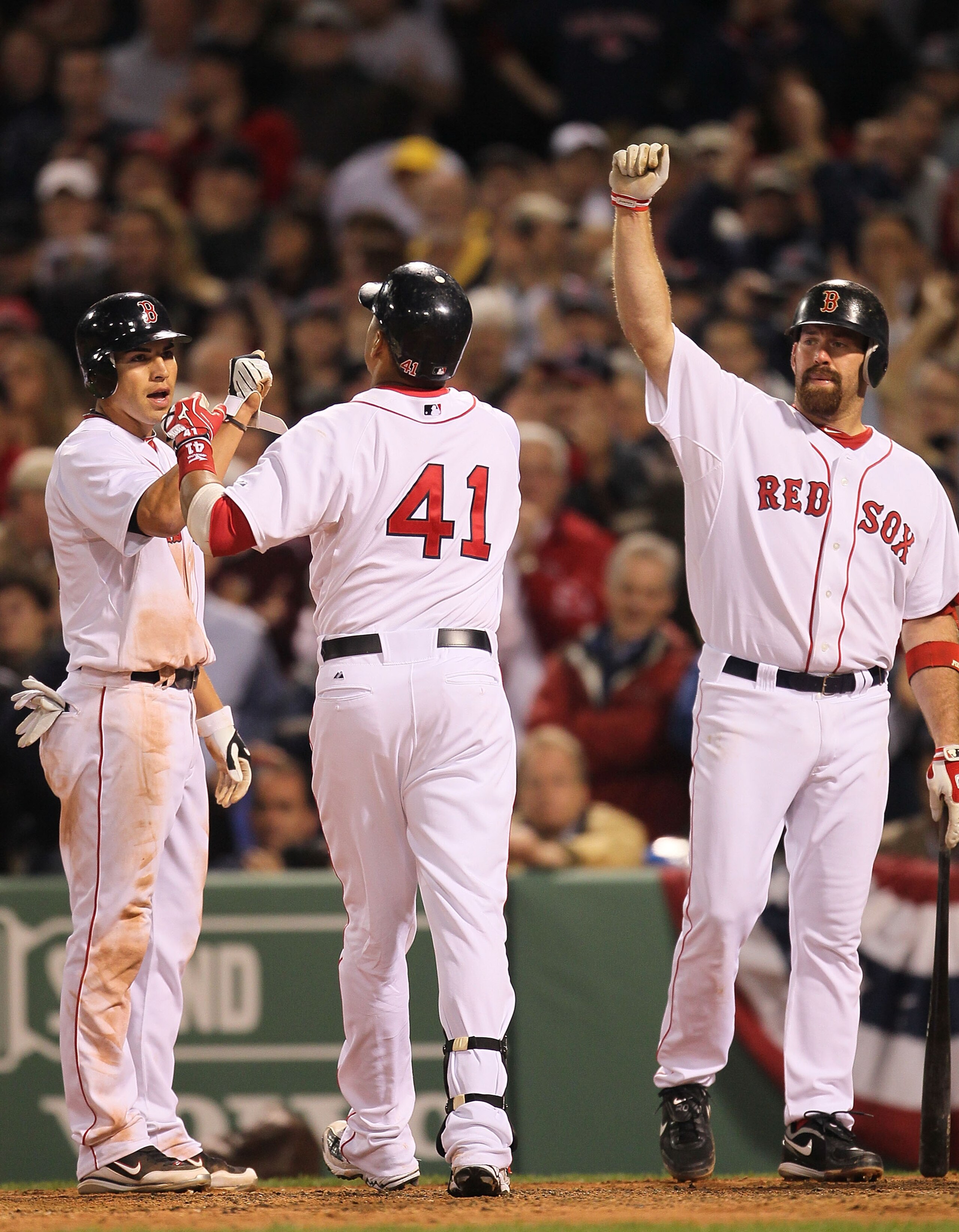 BOSTON - APRIL 06:  Victor Martinez #41 celebrates his home run with Jacoby Ellsbury #2 and Kevin Youkilis #20, all of the Boston Red Sox against the New york Yankees attempts to field an errant at Fenway Park on April 6, 2010 in Boston, Massachusetts. (P