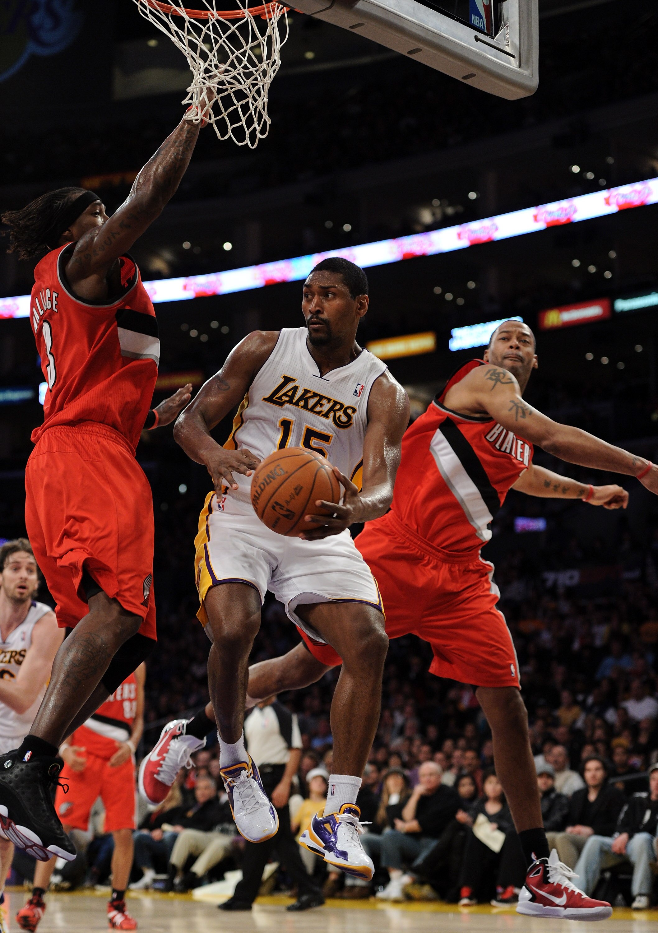 LOS ANGELES, CA - MARCH 20:  Ron Artest #15 of the Los Angeles Lakers looks to make a pass as he is defended by Marcus Camby #23 and Gerald Wallace #3 of the Portland Trail Blazers at the Staples Center on March 20, 2011 in Los Angeles, California.  NOTE