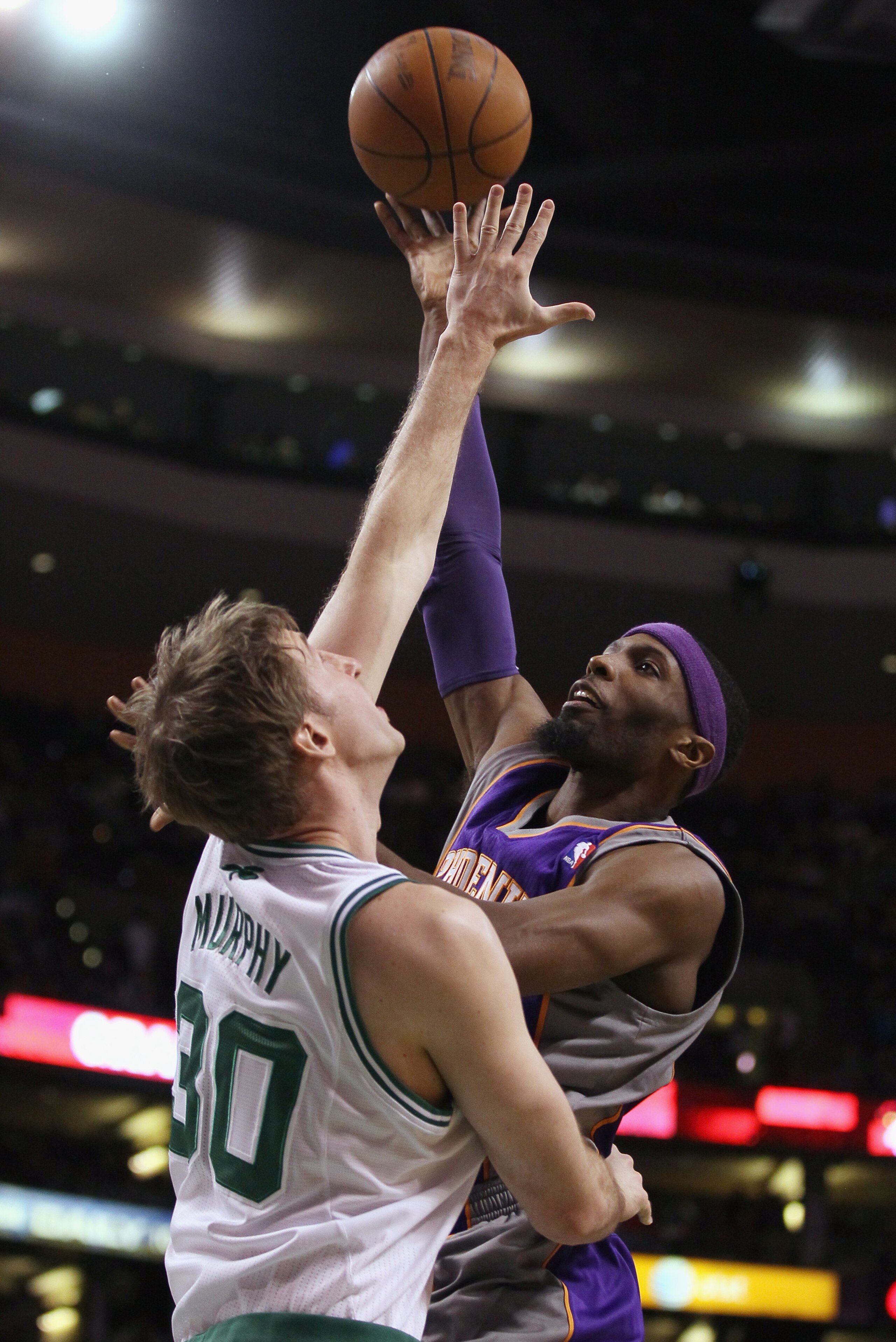 BOSTON, MA - MARCH 02:  Hakim Warrick #21 of the Phoenix Suns takes a shot as Troy Murphy #30 of the Boston Celtics defends on March 2, 2011 at the TD Garden in Boston, Massachusetts.  The Celtics defeated the Suns 115-103. NOTE TO USER: User expressly ac
