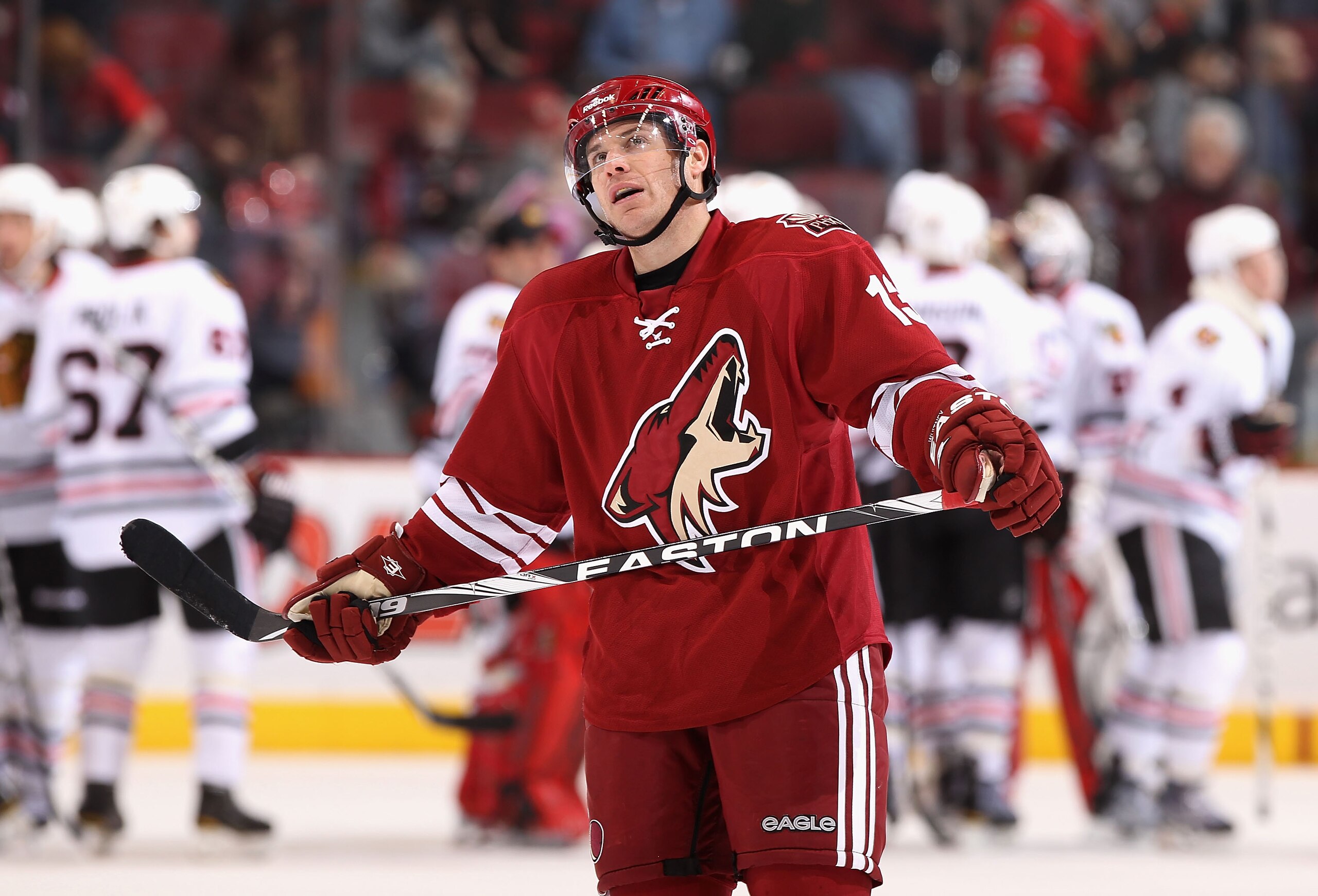 GLENDALE, AZ - MARCH 20:  Ray Whitney #13 of the Phoenix Coyotes skates off the ice as the Chicago Blackhawks celebrate their win following the NHL game at Jobing.com Arena on March 20, 2011 in Glendale, Arizona. The Blackhawks defeated the Coyotes 2-1. (