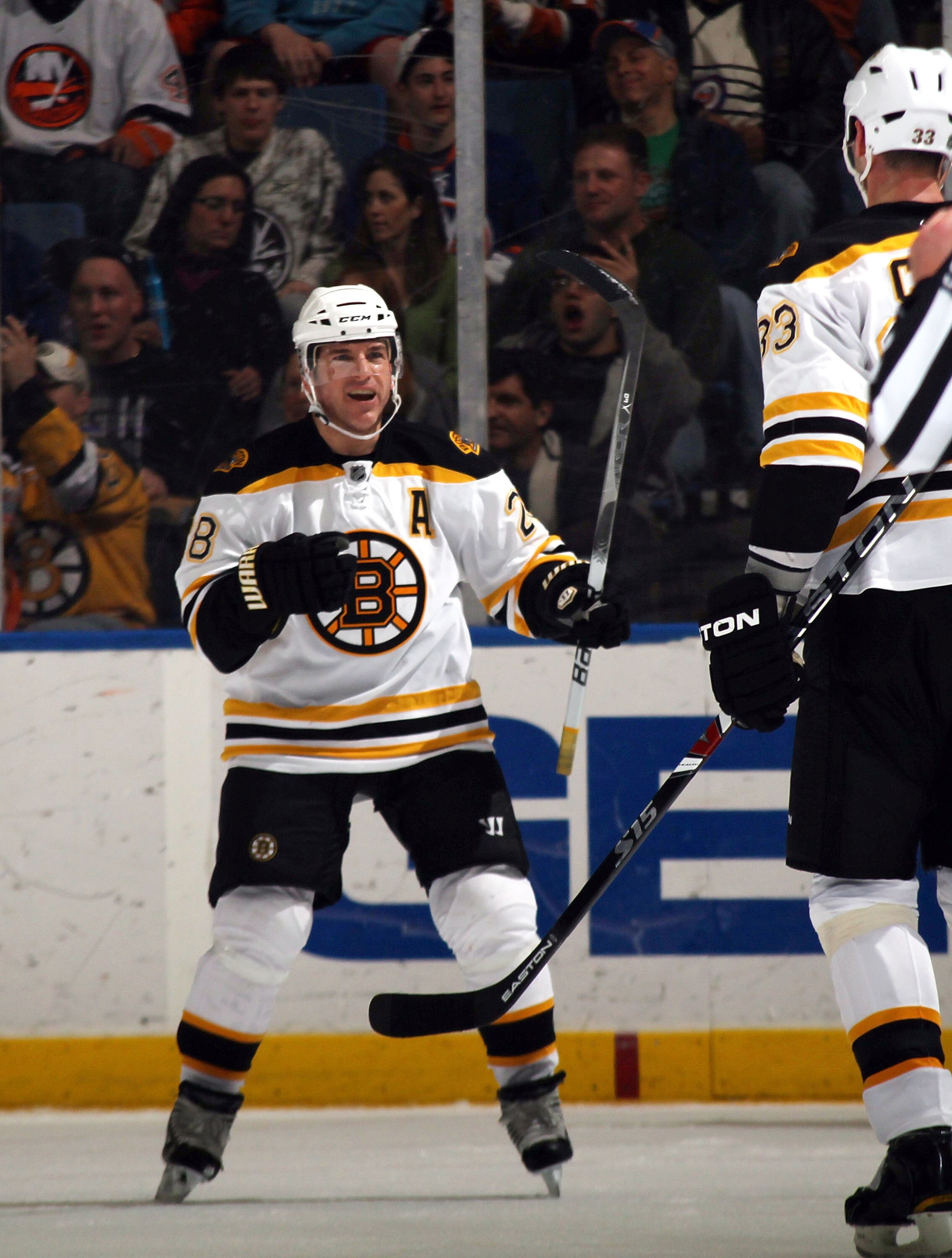 UNIONDALE, NY - MARCH 11: Mark Recchi #28 of the Boston Bruins celebrates a second period power play goal by Zdeno Chara #33 in their game against the New York Islanders at the Nassau Coliseum on March 11, 2011 in Uniondale, New York.  (Photo by Bruce Ben