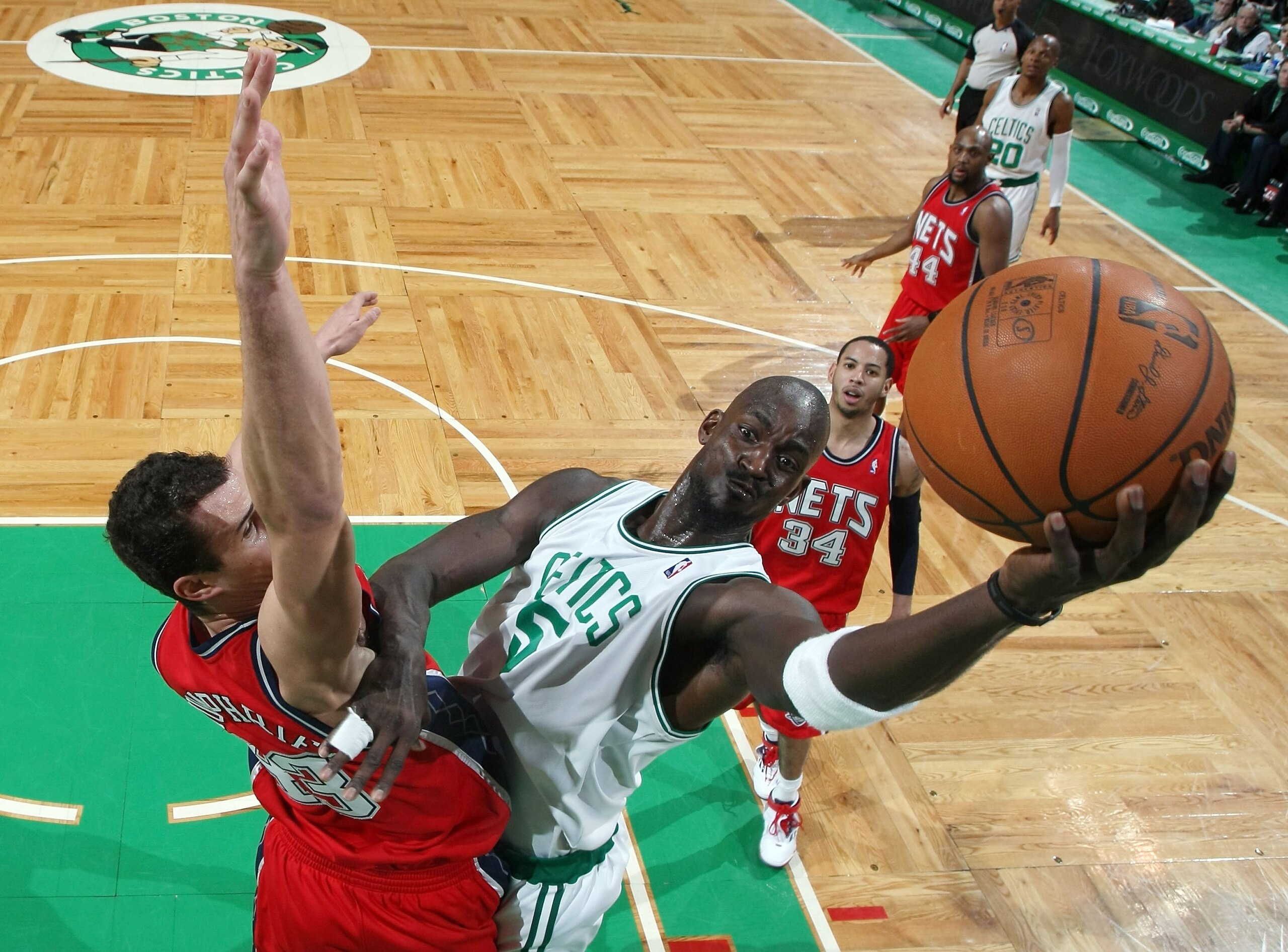 BOSTON - FEBRUARY 27:  Kevin Garnett #5 of the Boston Celtics takes a shot as Kris Humphries #43 of the New Jersey Nets defends at the TD Garden on February 27, 2010 in Boston, Massachusetts. The Nets defeated the Celtics 104-96.  NOTE TO USER: User expre