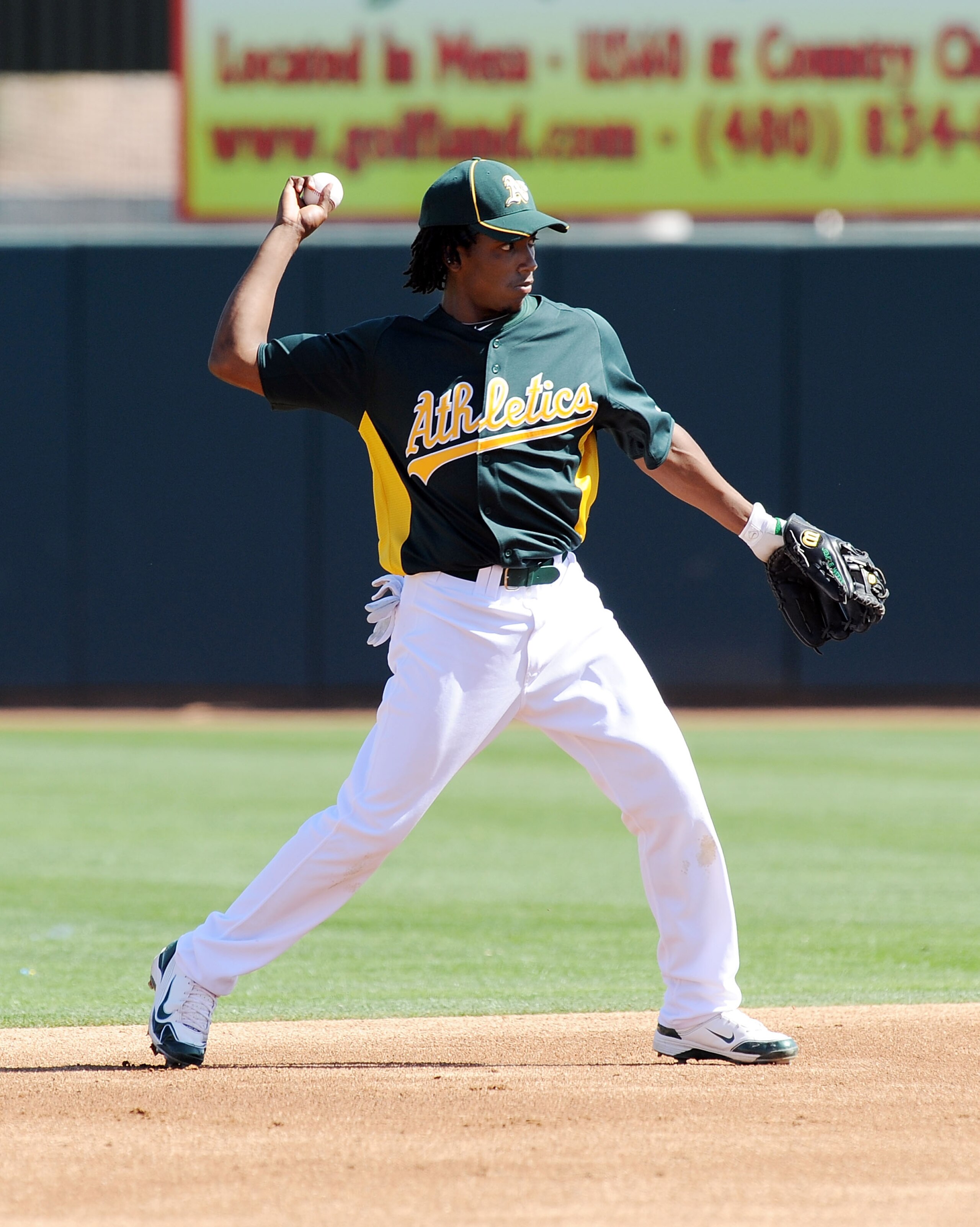 PHOENIX, AZ - MARCH 04:  Jemile Weeks #59 of the Oakland Athletics throws the ball to first base against the Texas Rangers at Phoenix Municipal Stadium on March 4, 2011 in Phoenix, Arizona.  (Photo by Norm Hall/Getty Images)