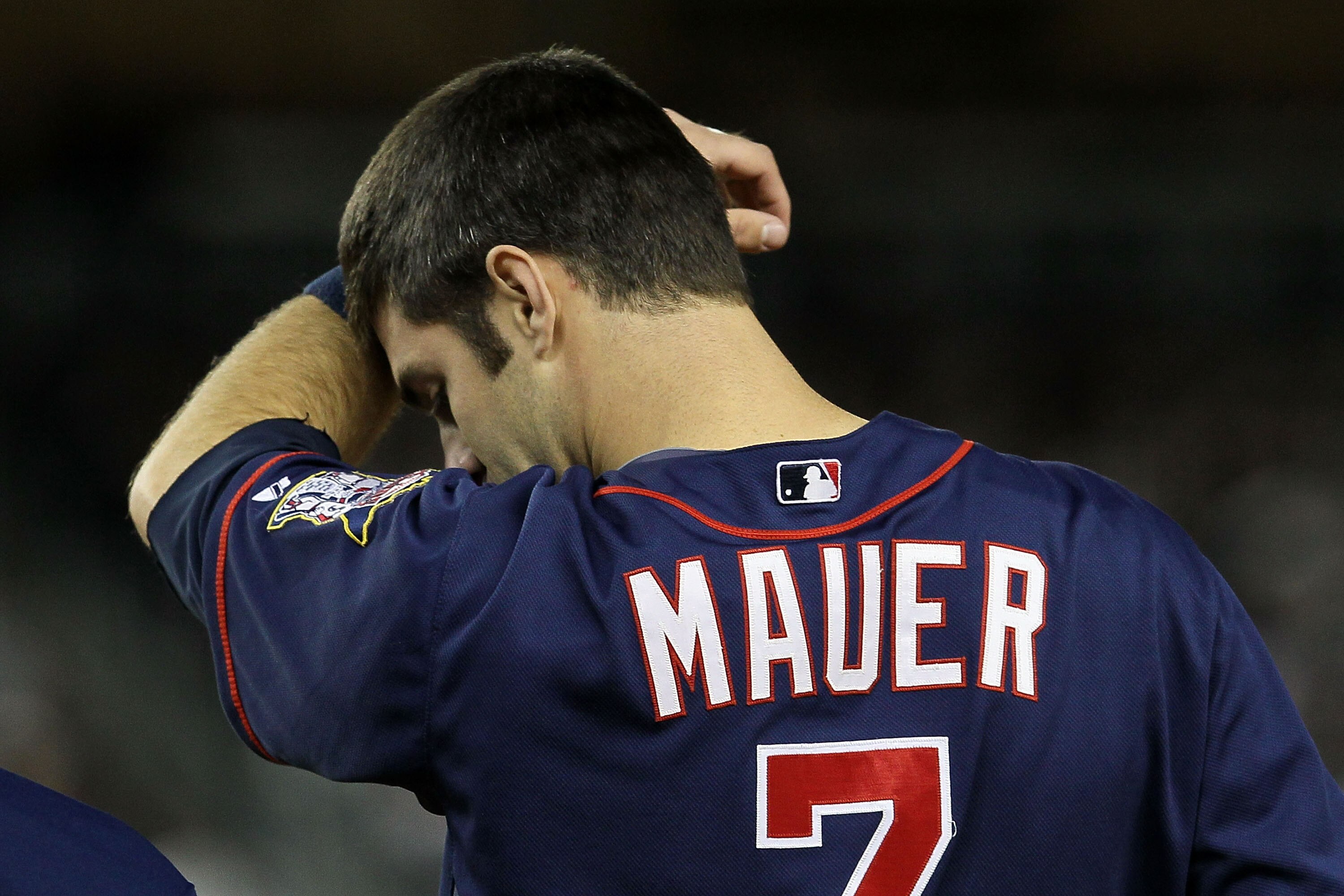 NEW YORK - OCTOBER 09:  Joe Mauer #7 of the Minnesota Twins wipes his forehead against the New York Yankees during Game Three of the ALDS part of the 2010 MLB Playoffs at Yankee Stadium on October 9, 2010 in the Bronx borough of New York City.  (Photo by 