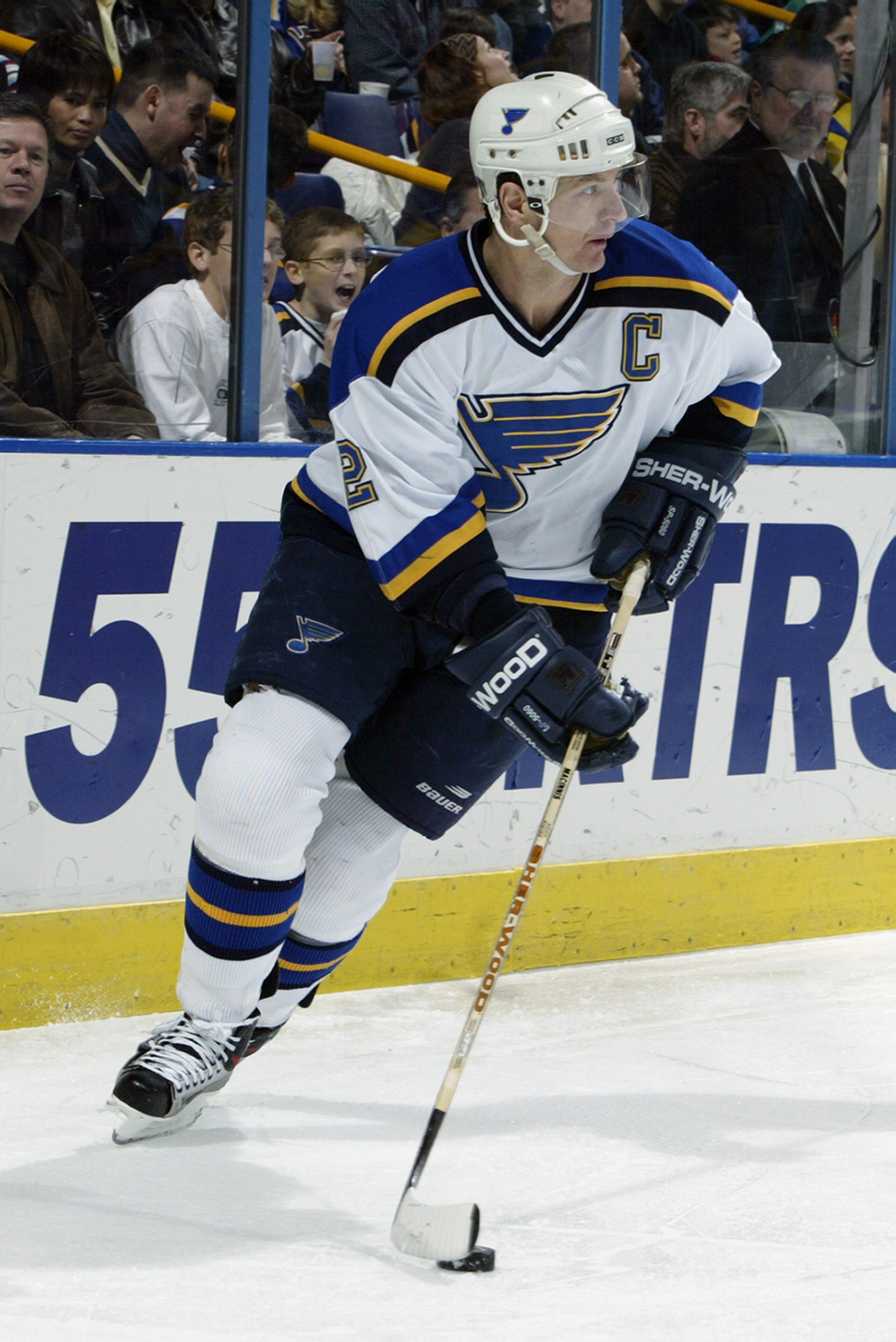 ST. LOUIS - FEBRUARY 17:  Al MacInnis #2 of the St. Louis Blues skates with the puck during the NHL game against the Calgary Flames at the Savvis Center on February 17, 2003 in St. Louis, Missouri. The Blues defeated the Flames 5-3.  (Photo by Elsa/Getty