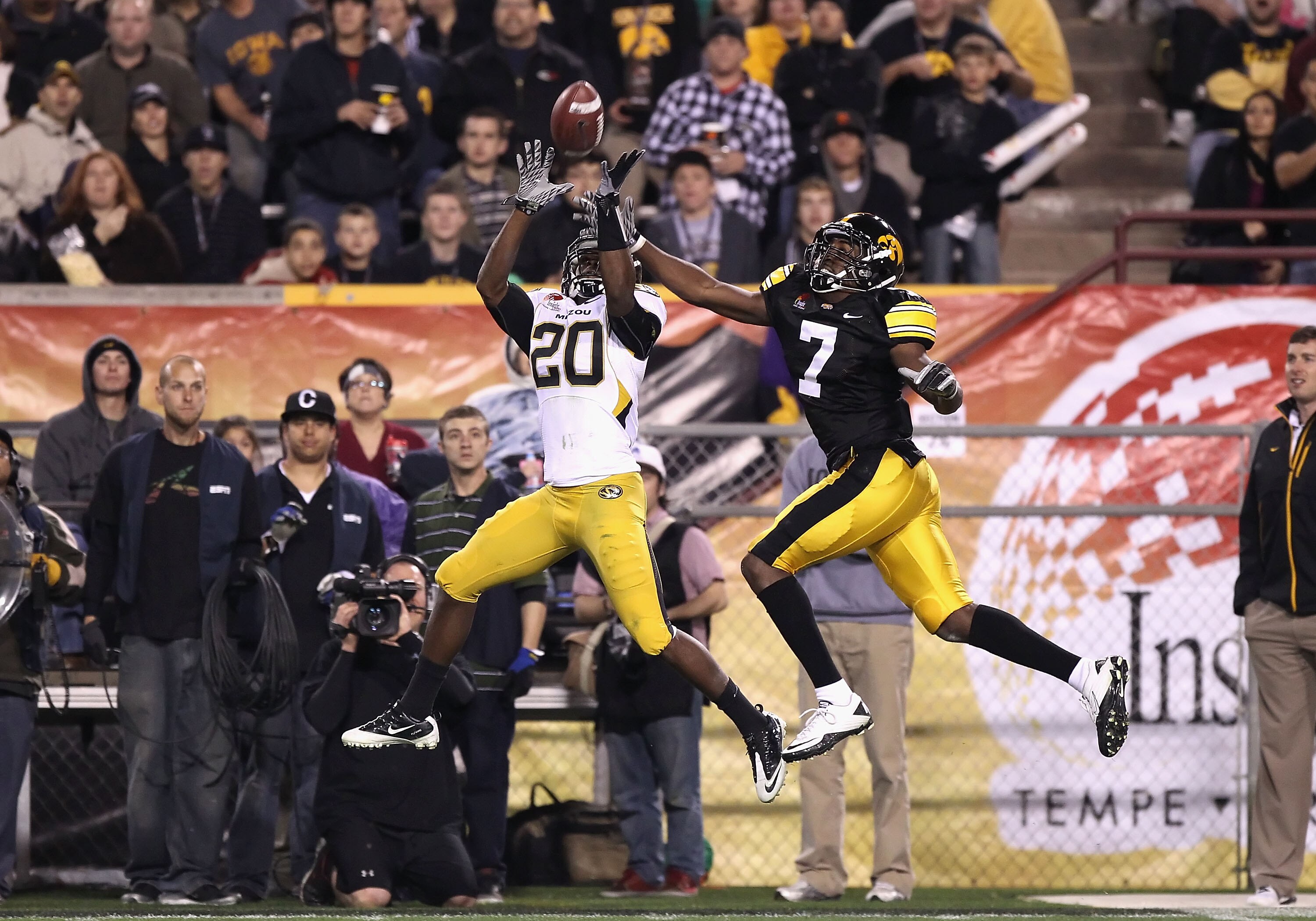 TEMPE, AZ - DECEMBER 28:  Defensive back Kevin Rutland #20 of the Missouri Tigers intercepts a pass intended for Marvin McNutt #7 of the Iowa Hawkeyes during the third quarter of the Insight Bowl at Sun Devil Stadium on December 28, 2010 in Tempe, Arizona
