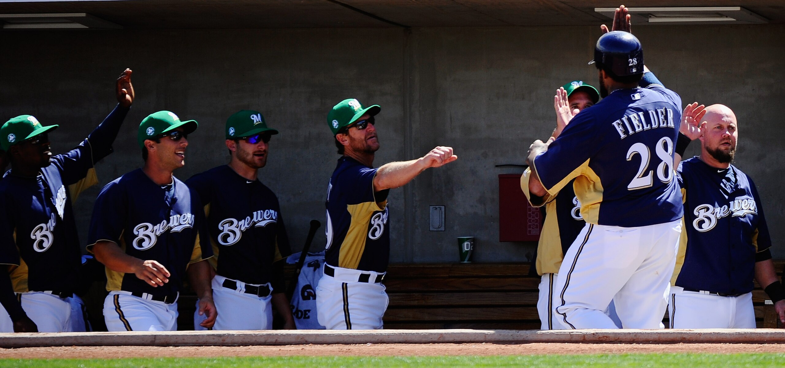 PHOENIX, AZ - MARCH 17:  Prince Fielder #28 of the Milwaukee Brewers is congratulated by teammates after scoring on a two-run double by Jeremy Reed #62 against pitcher Edwin Jackson #33 of the Chicago White Sox during the first inning of the spring traini