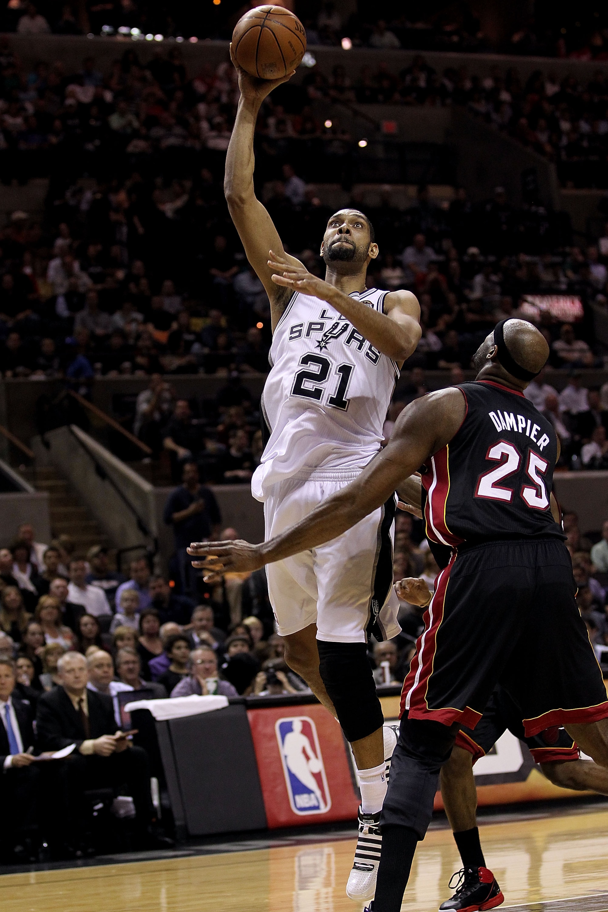 SAN ANTONIO, TX - MARCH 04:  Forward Tim Duncan #21 of the San Antonio Spurs takes a shot against Erick Dampier #25 of the Miami Heat at AT&T Center on March 4, 2011 in San Antonio, Texas.   NOTE TO USER: User expressly acknowledges and agrees that, by do
