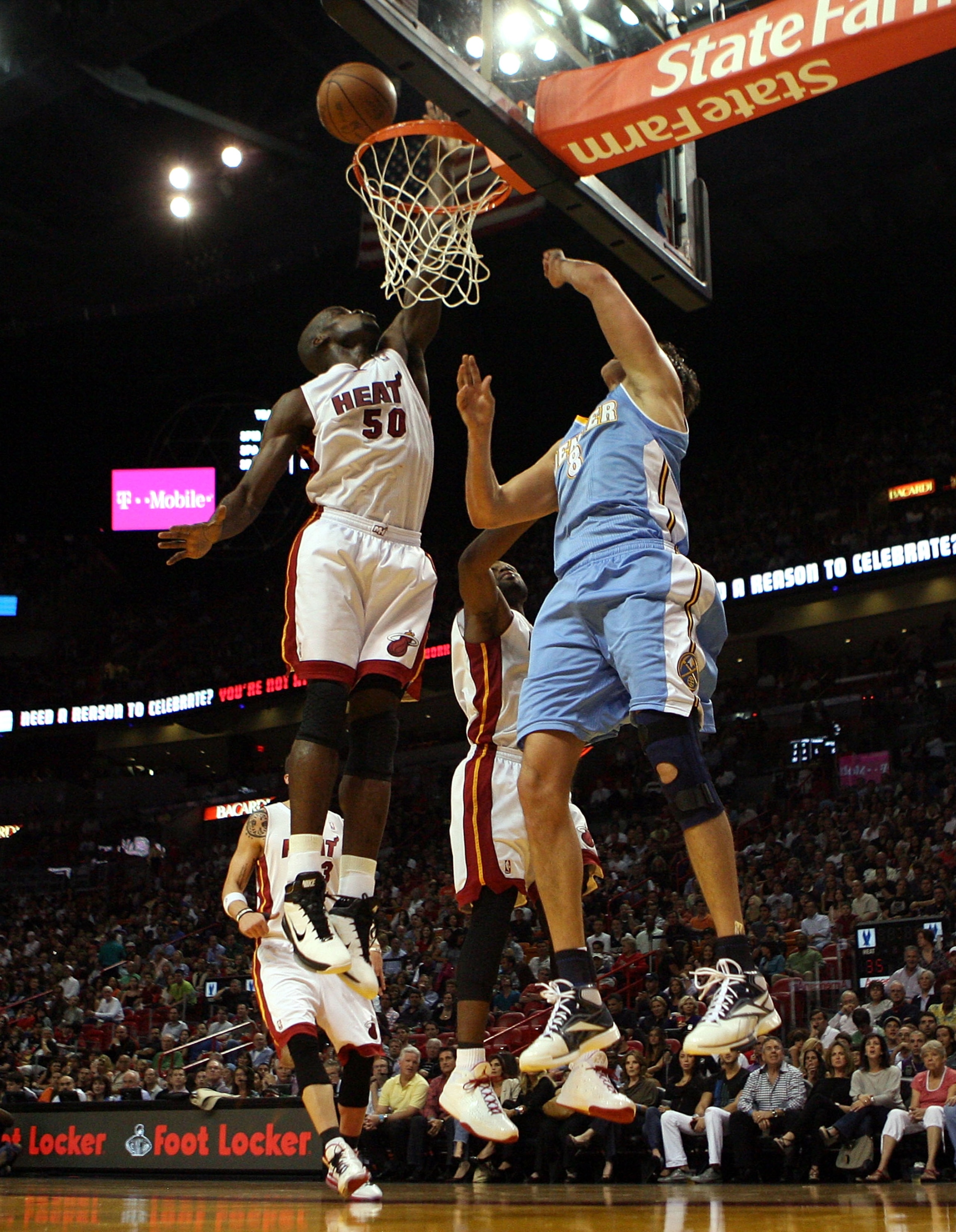 MIAMI, FL - MARCH 19:  Center Joel Anthony #50 of the Miami Heat blocks the shot of Forward Danilo Gallinaro #8 of the Denver Nuggets at American Airlines Arena on March 19, 2011 in Miami, Florida.  The Heat defeated the Nuggets 103-98. NOTE TO USER: User