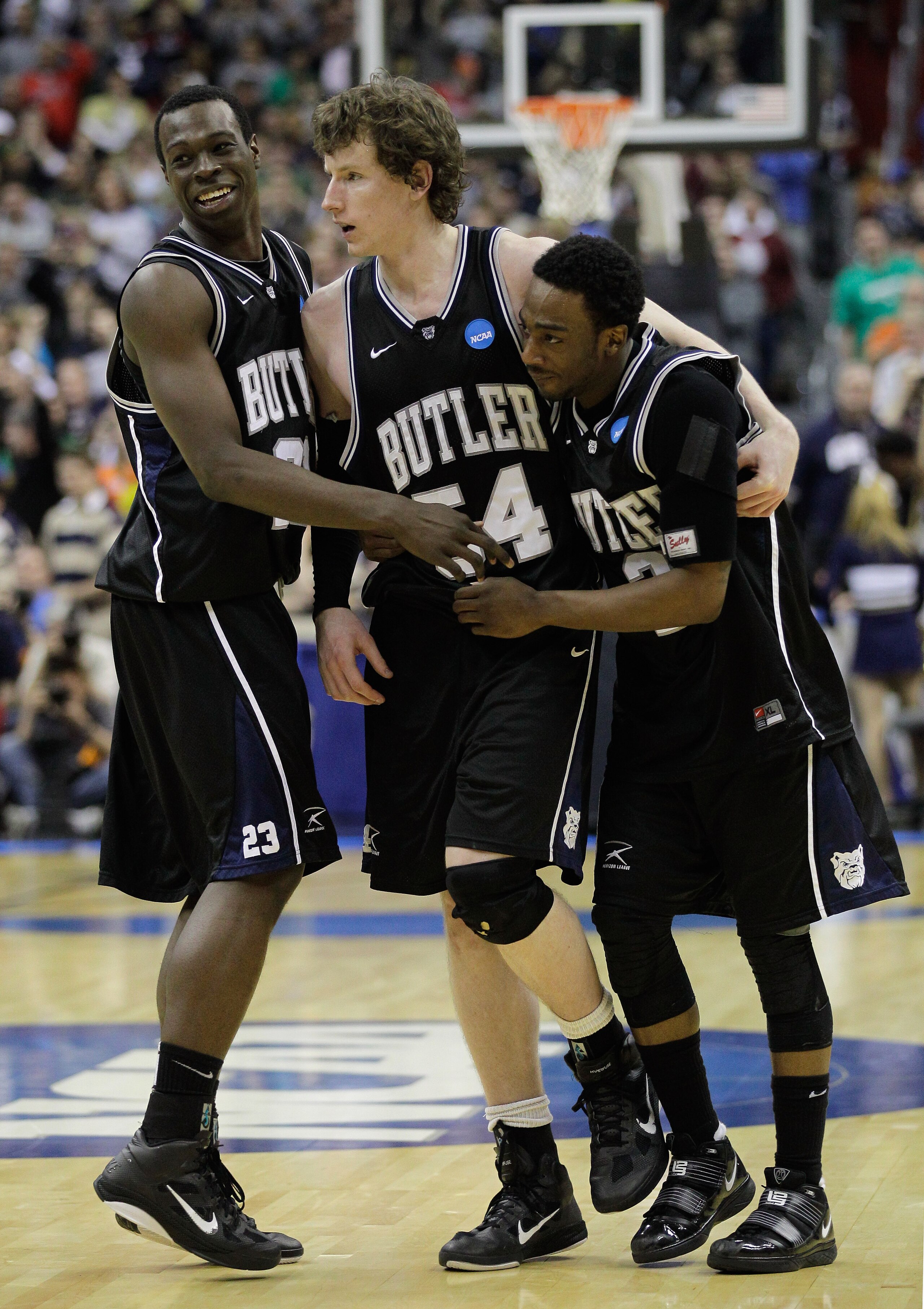 WASHINGTON - MARCH 19:  After making the game winning free throw, Matt Howard #54 of Butler is embraced by teammates Zach Hahn #3 and Khyle Marshall #23 in the third round of the 2011 NCAA men's basketball tournament at Verizon Center on March 19, 2011 in