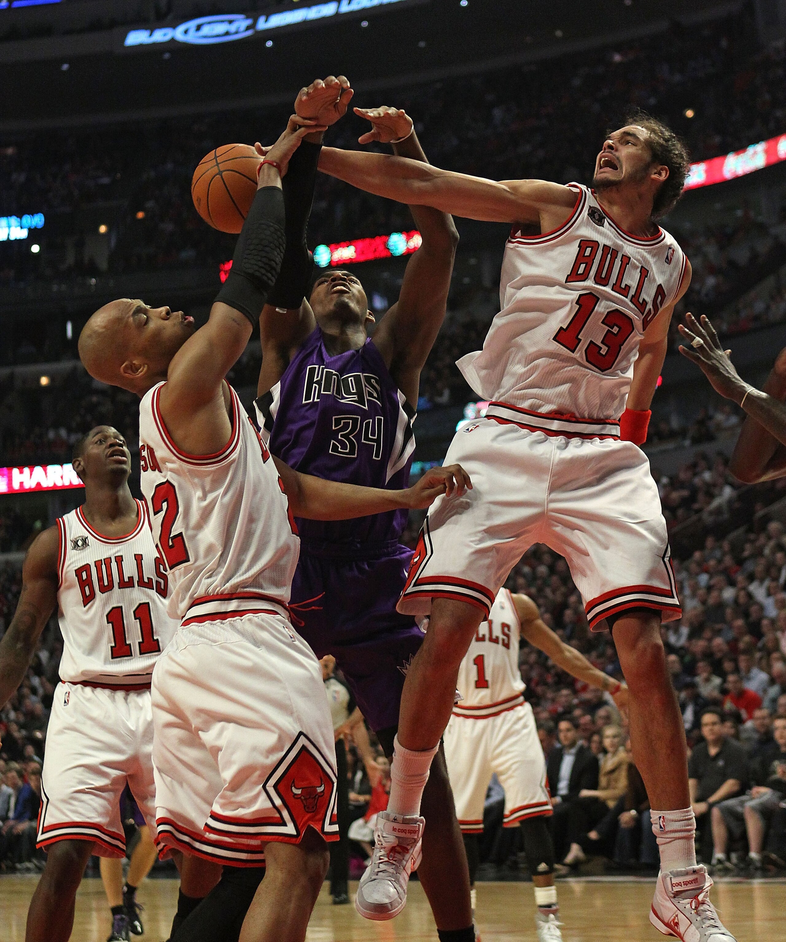 CHICAGO, IL - MARCH 21: Joakim Noah #13 of the Chicago Bulls blocks a shot by Jason Thompson #34 of the Sacramento Kings as teammate Taj Gibson #22 also defends at the United Center on March 21, 2011 in Chicago, Illinois. NOTE TO USER: User expressly ackn
