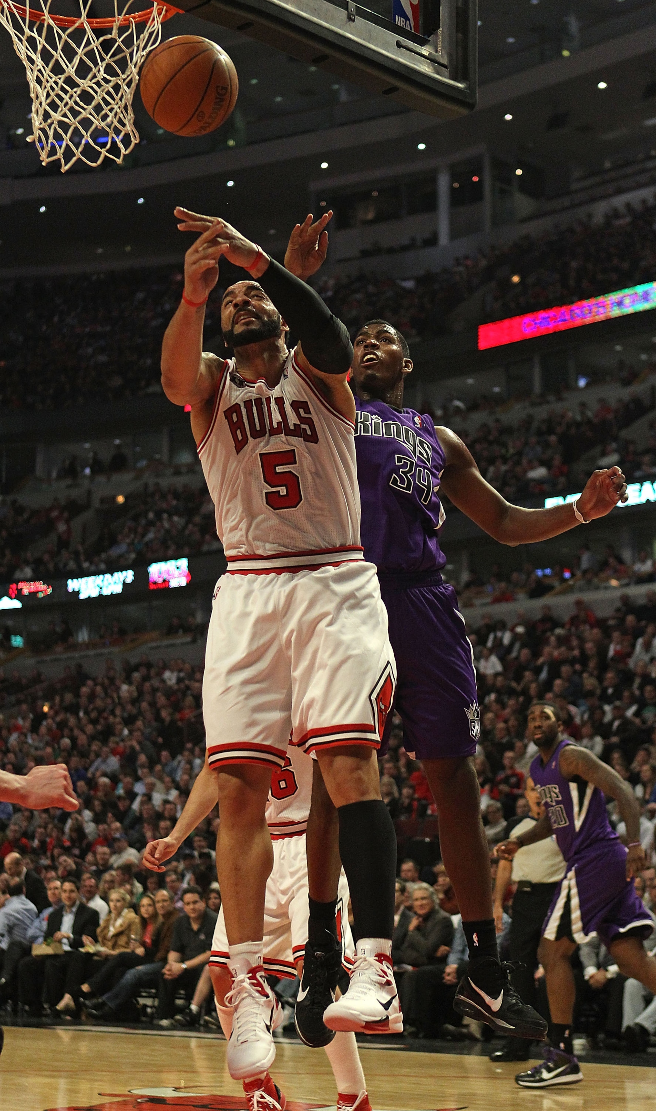 CHICAGO, IL - MARCH 21: Carlos Boozer #5 of the Chicago Bulls is fouled while rebounding by Jason Thompson #34 of the Sacramento Kings at the United Center on March 21, 2011 in Chicago, Illinois. NOTE TO USER: User expressly acknowledges and agrees that,