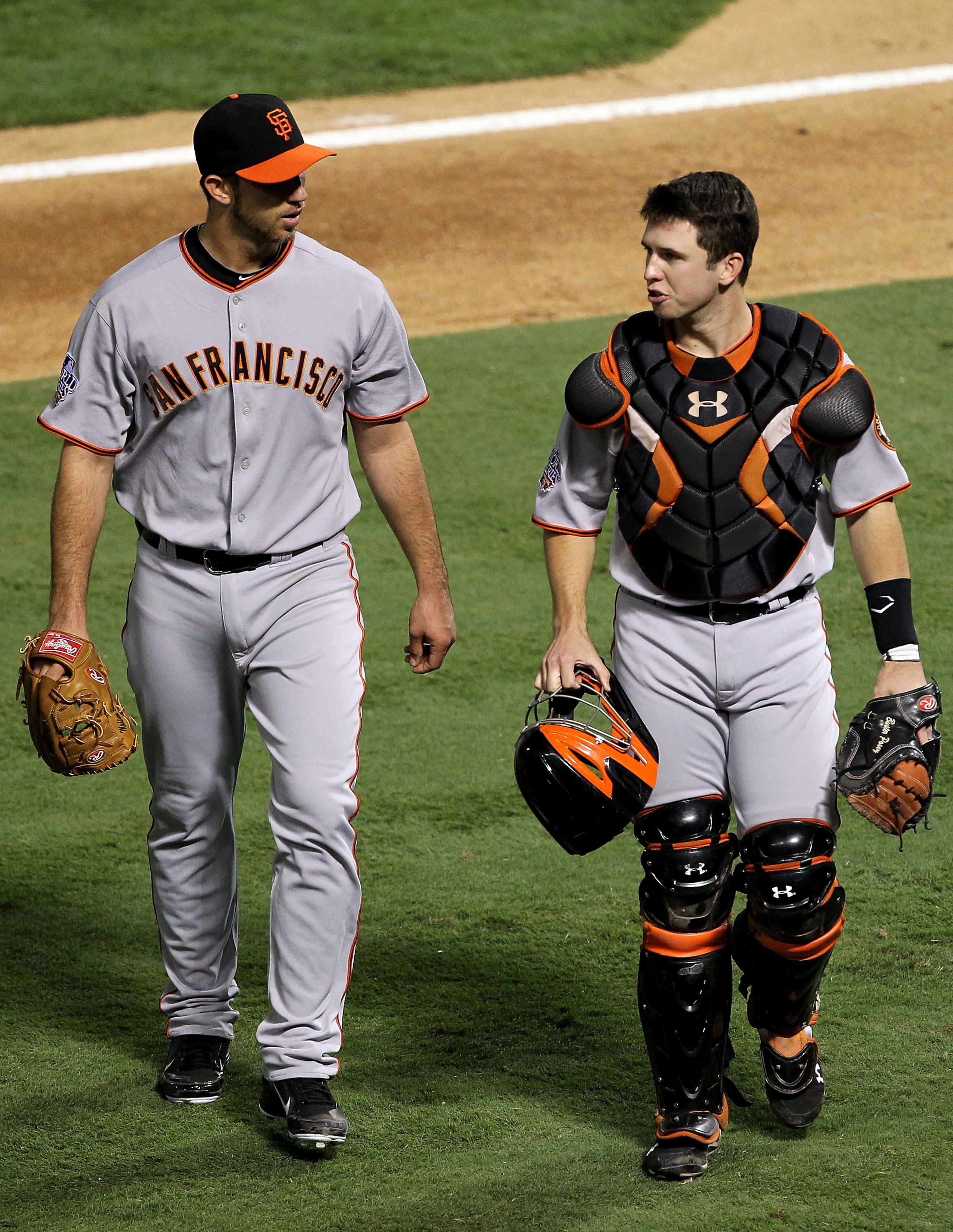ARLINGTON, TX - OCTOBER 31:  Starting pitcher Madison Bumgarner #40 of the San Francisco Giants walks off the field with Buster Posey #55 in the fifth inning against the Texas Rangers in Game Four of the 2010 MLB World Series at Rangers Ballpark in Arling