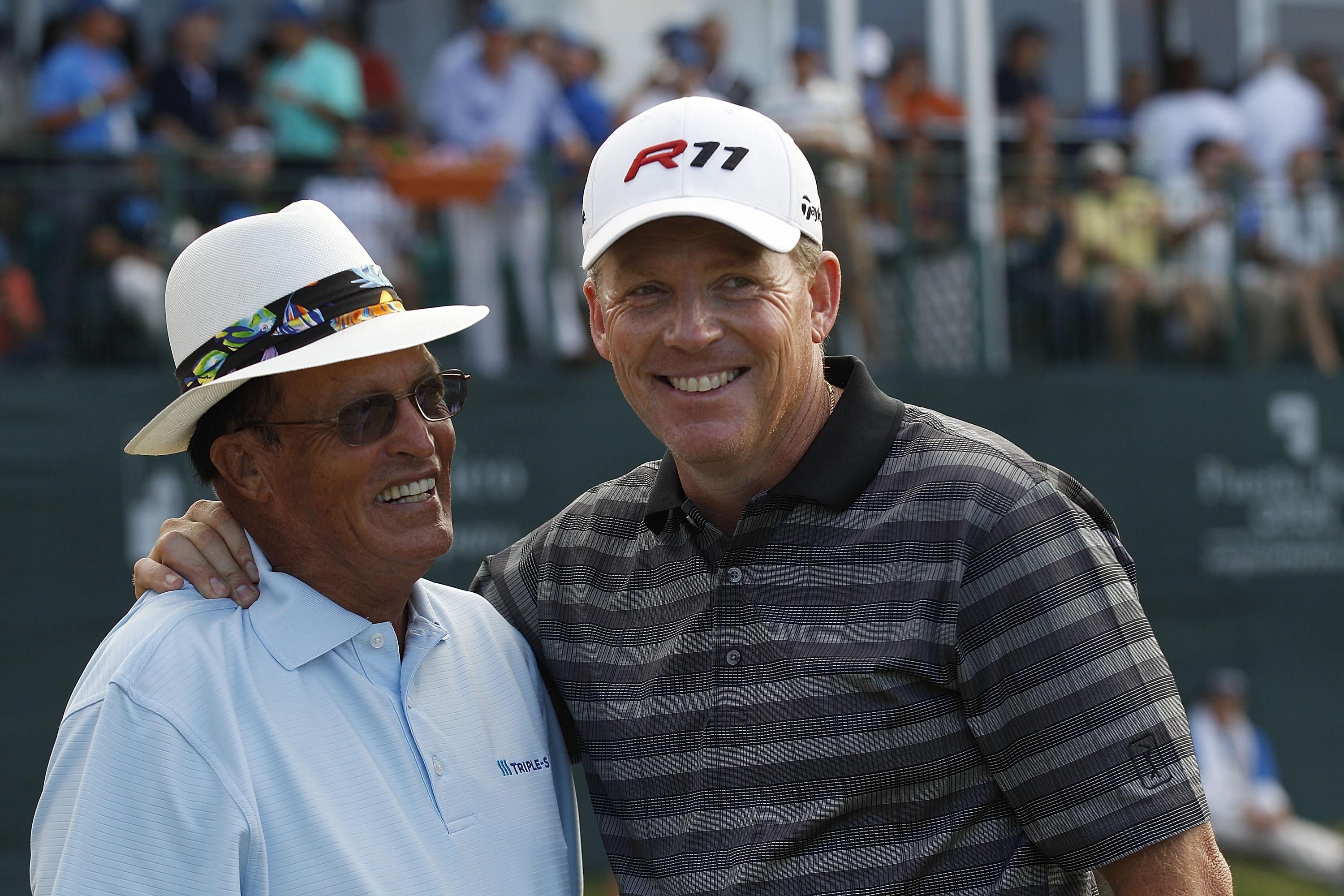RIO GRANDE, PR - MARCH 13:  Michael Bradley (R) is congratulated by Chi Chi Rodriguez after Bradley won a one hole playoff at the Puerto Rico Open presented by seepuertorico.com at Trump International Golf Club on March 13, 2011 in Rio Grande, Puerto Rico