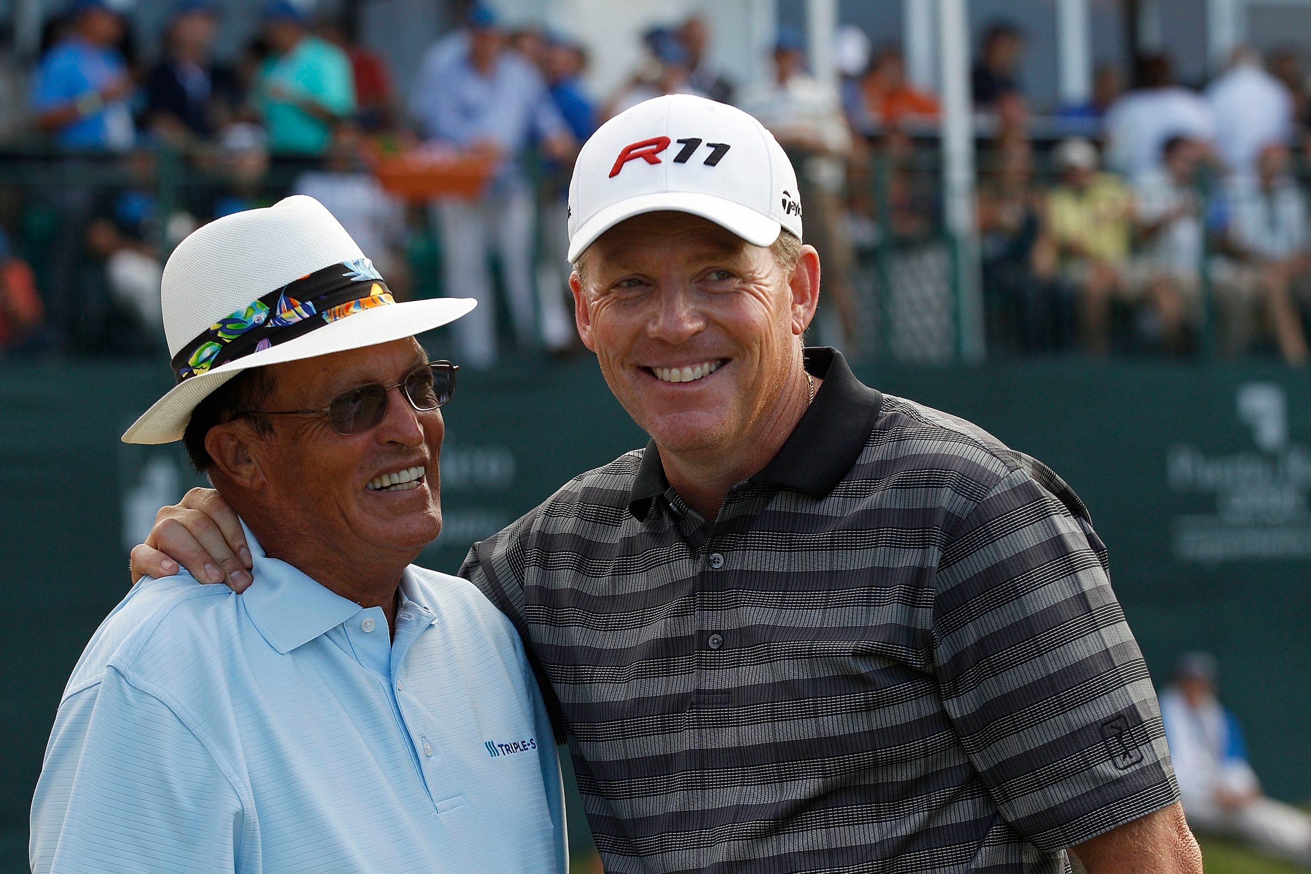 RIO GRANDE, PR - MARCH 13:  Michael Bradley (R) is congratulated by Chi Chi Rodriguez after Bradley won a one hole playoff at the Puerto Rico Open presented by seepuertorico.com at Trump International Golf Club on March 13, 2011 in Rio Grande, Puerto Rico