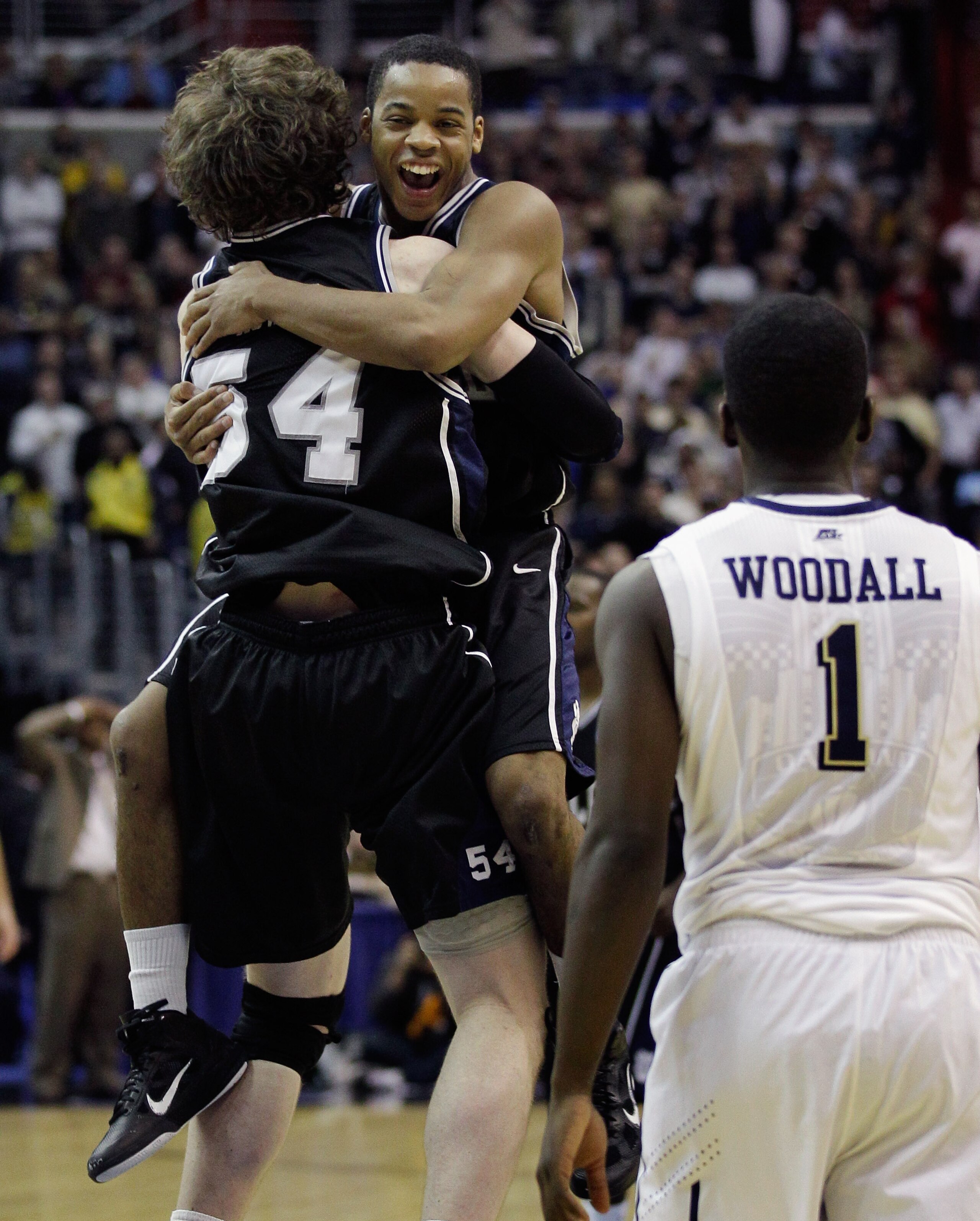 WASHINGTON - MARCH 19:  After making the game winning free throw, Matt Howard #54 of Butler jumps into the arms of teammate Zach Hahn #3 as Pittsburgh's Travon Woodall #3 looks on following  their game in the third round of the 2011 NCAA men's basketball