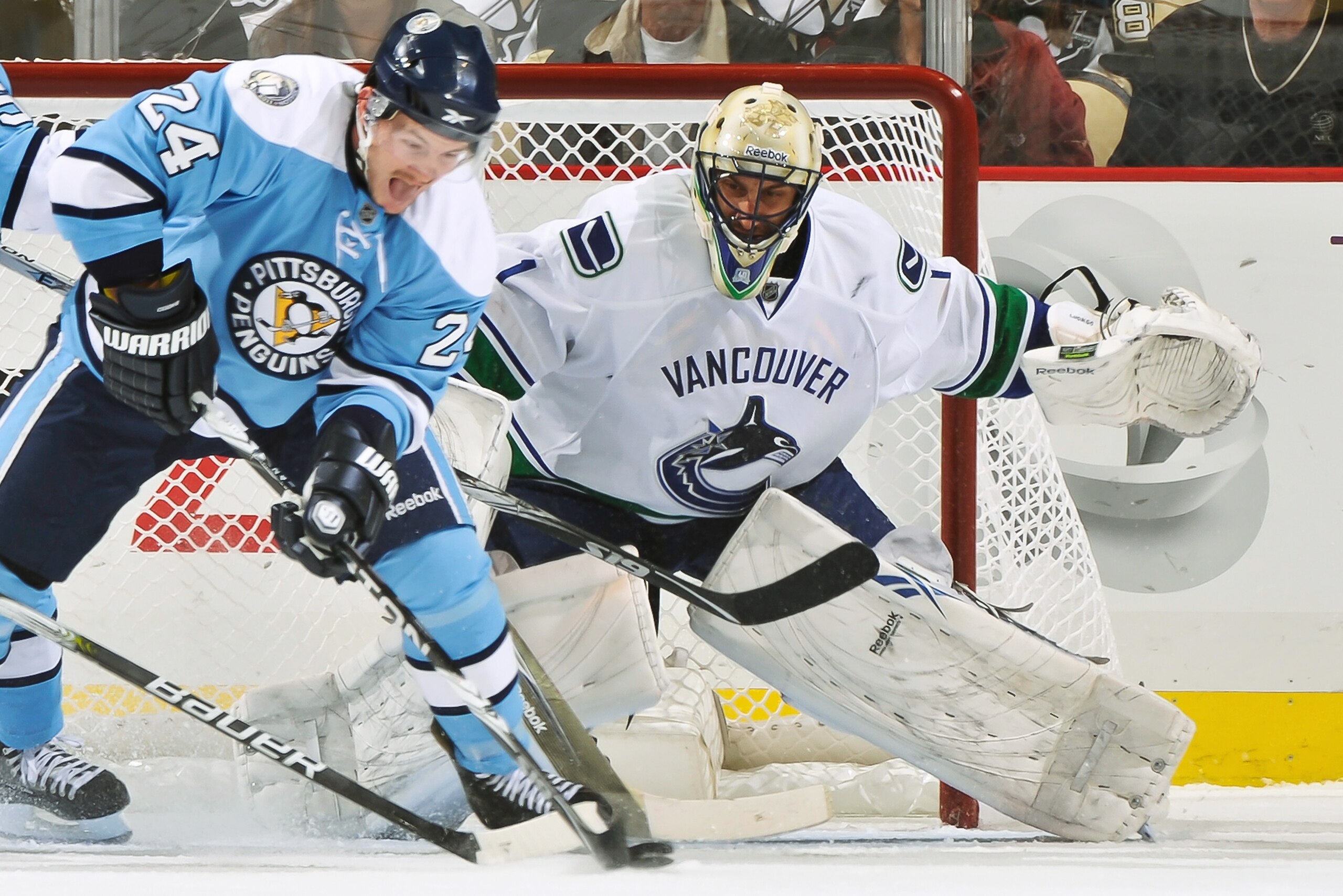 PITTSBURGH - NOVEMBER 17:  Goaltender Roberto Luongo #1 of the Vancouver Canucks defends the net as Matt Cooke #24 of the Pittsburgh Penguins attempts to score on November 17, 2010 at Consol Energy Center in Pittsburgh, Pennsylvania.  (Photo by Jamie Saba
