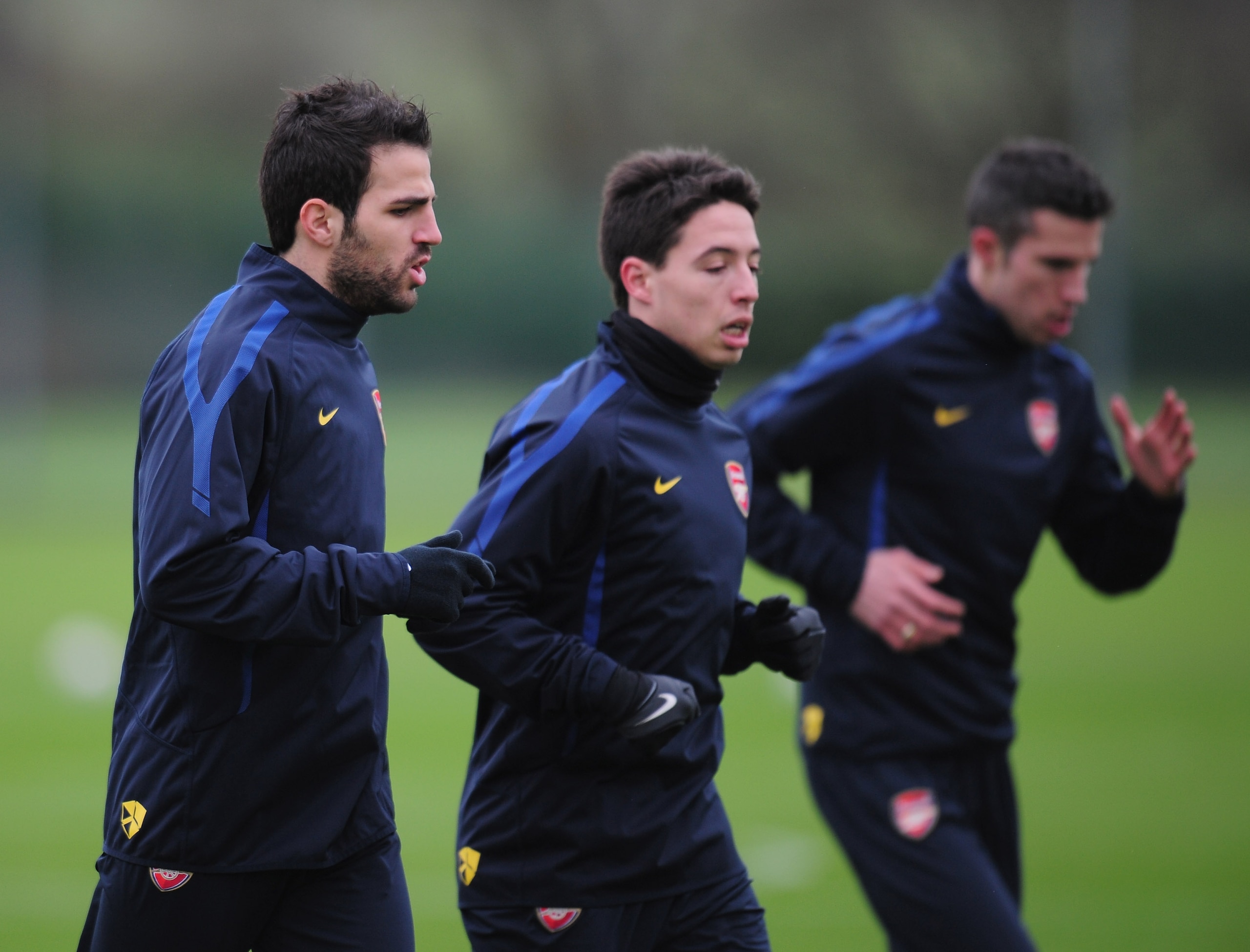 ST ALBANS, ENGLAND - FEBRUARY 15:  Cesc Fabregas, Samir Nasri and Robin Van Persie of Arsenal warm-up during training at London Colney on February 15, 2011 in St Albans, England.  (Photo by Shaun Botterill/Getty Images)